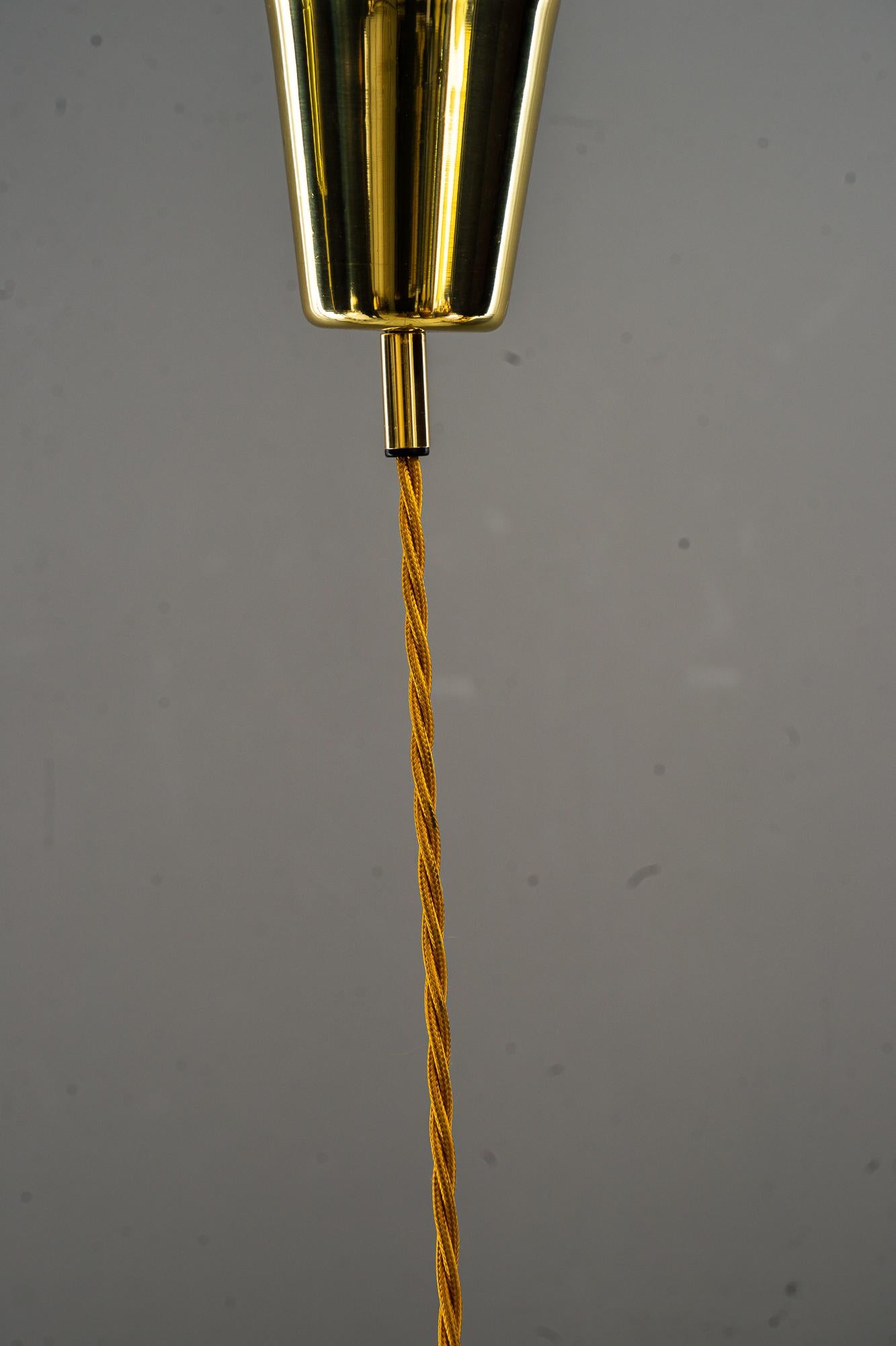 Richard Essig Pendant Germany around 1960s.
Brass parts polished and stove enameled.