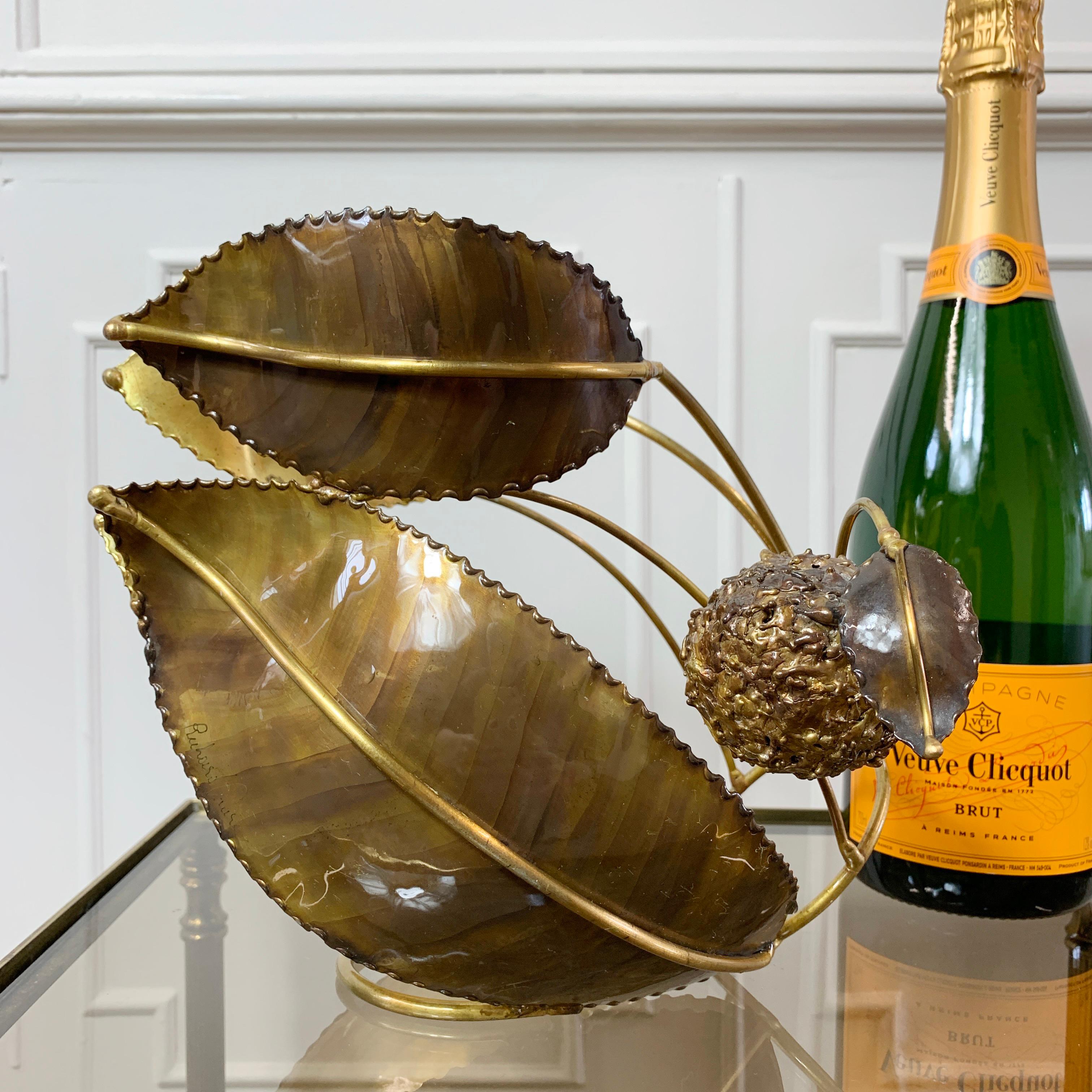 An exceptional signed sculptured wine bottle cradle by the renowned French Artist and Sculptor Richard Faure.

Hand crafted in brass, and intricately detailed in the form of a chestnut with foliage, this rare and unique piece of art, is fully
