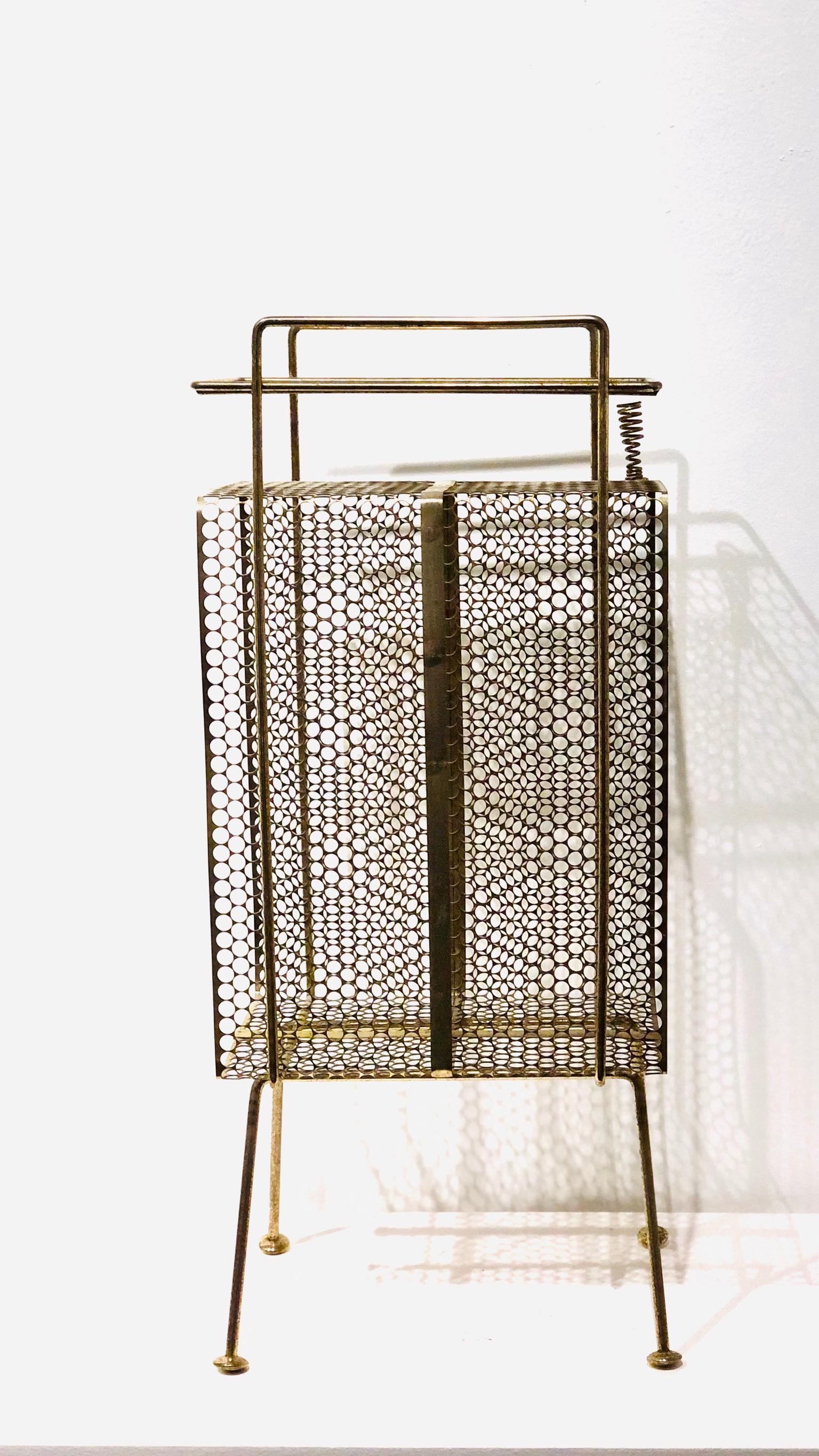 The 1950s Classic midcentury, atomic age era Stand/rack original used for the telephone, pen holder and phone directory, this one its in brass finish with some wear and patina due to age. Designed by Richard Galef for Ravenware.