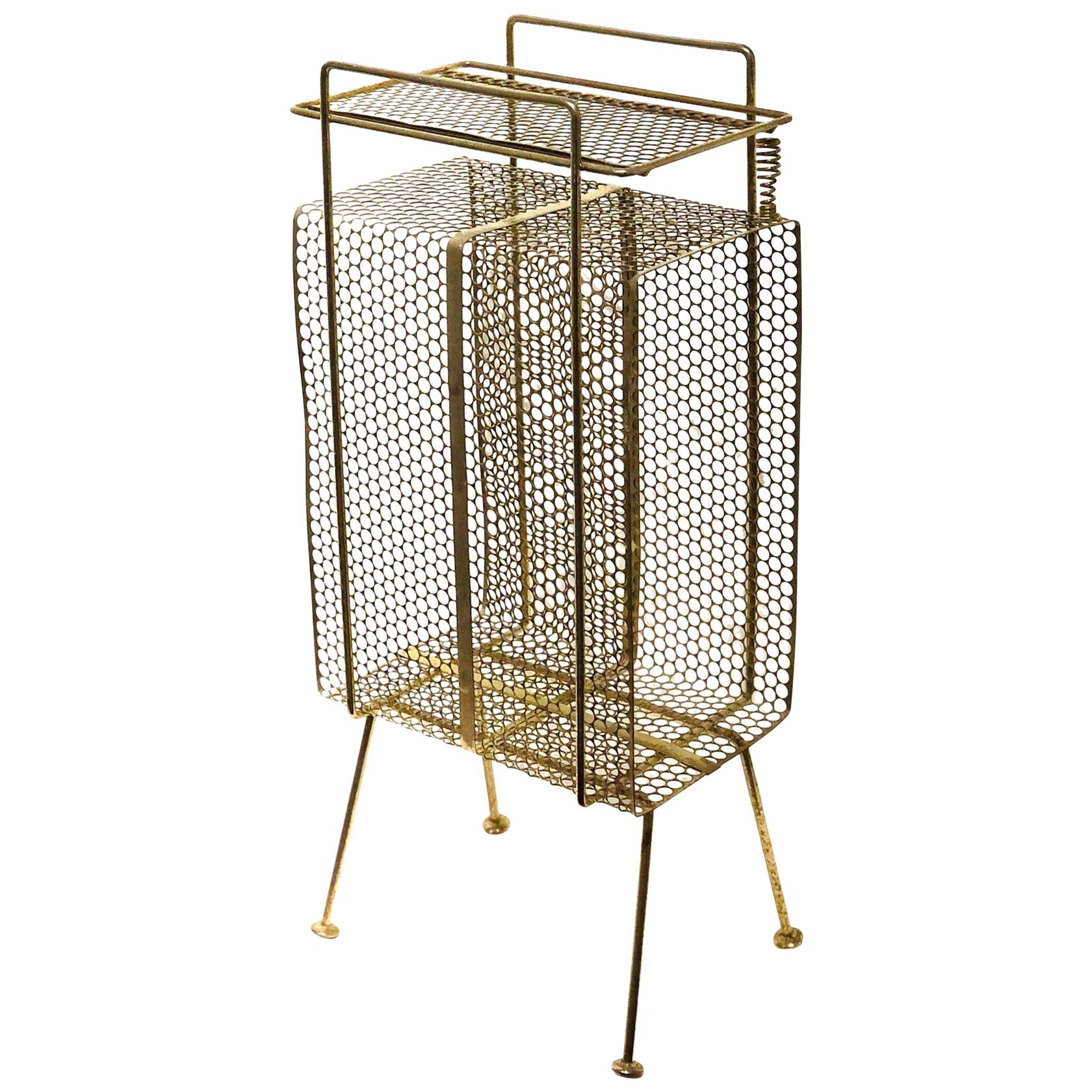 The 1950s Classic midcentury, atomic age era stand/rack original used for the telephone, phone directory, this one its in brass finish with some wear light rust and patina due to age. Designed by Richard Galef for Ravenware.