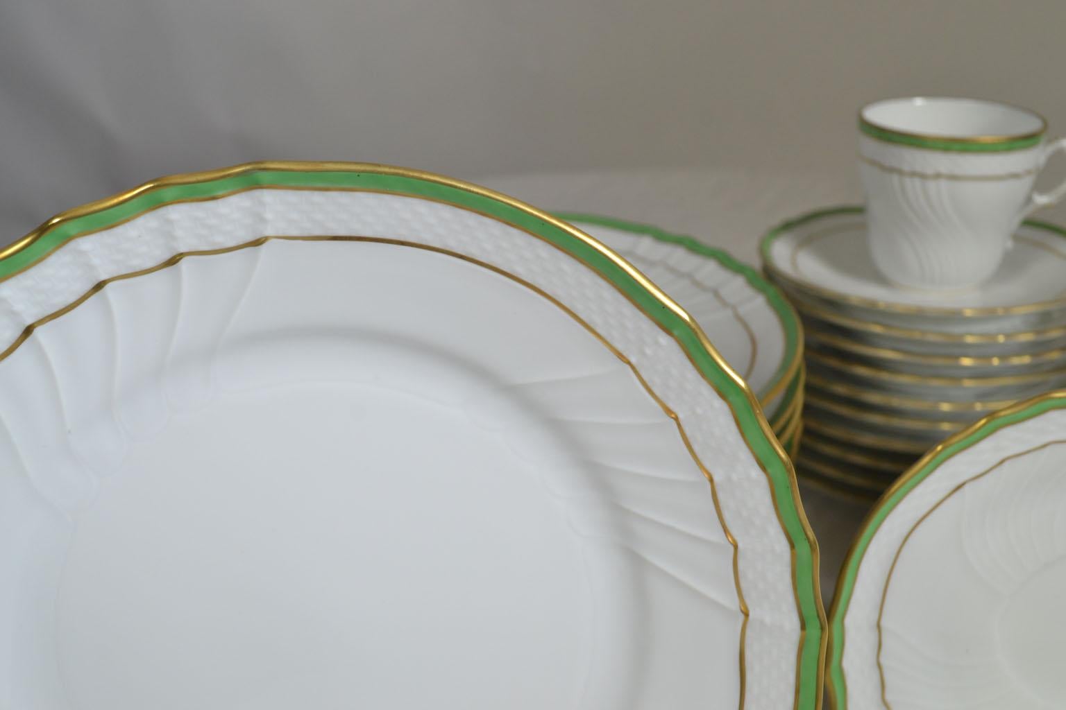 33-piece white and green porcelain Richard Ginori demitasse service for 8, with gilt trim, scalloped rims and brand stamp at undersides. Includes 12 dessert plates, 9 demitasse cups and 12 saucers. Made in Italy.