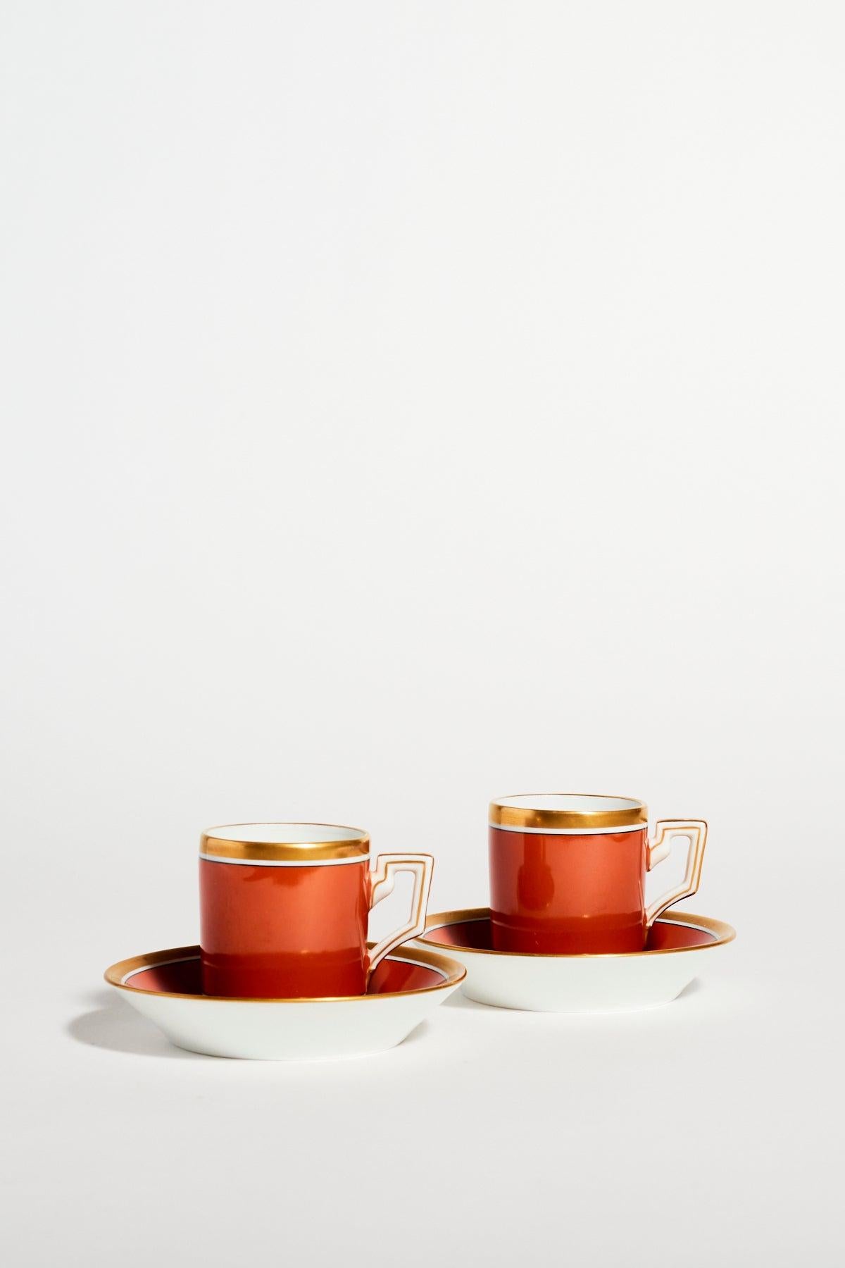 Richard Ginori quality porcelain demitasse set of two with elegant square handles in burnt orange, crisp white and gold accents.