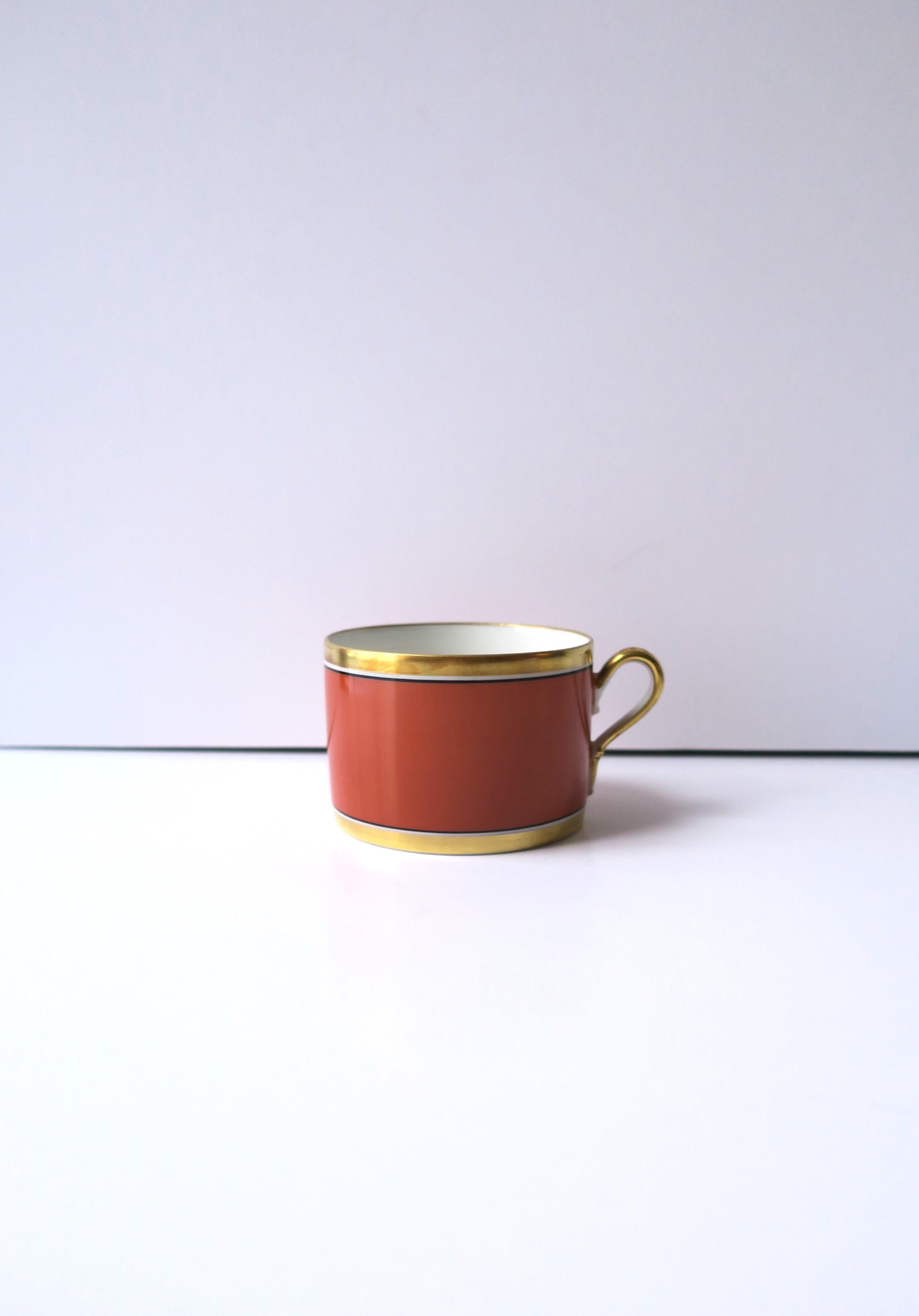 ** 12 cups available, each sold separately, as per listing. 

Vintage Italian Richard Ginori 'Contessa' gold and terracotta rust-red porcelain coffee or tea cup, circa late-20th century, Italy. Cups are hand-decorated with a gold band at base, top,