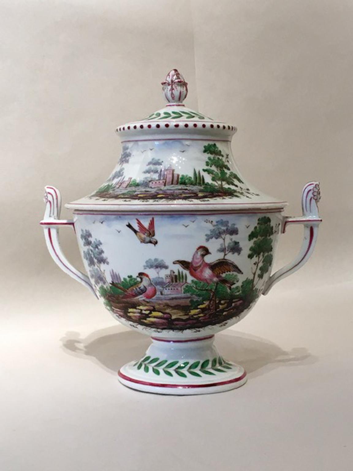 This glamorous covered vase or urn, it is painted with natural landscapes. The drawings are so detailed that we can say done in Flemish style. We can see a landscape with houses and castles at the orizont, and in another scene, birds and games.