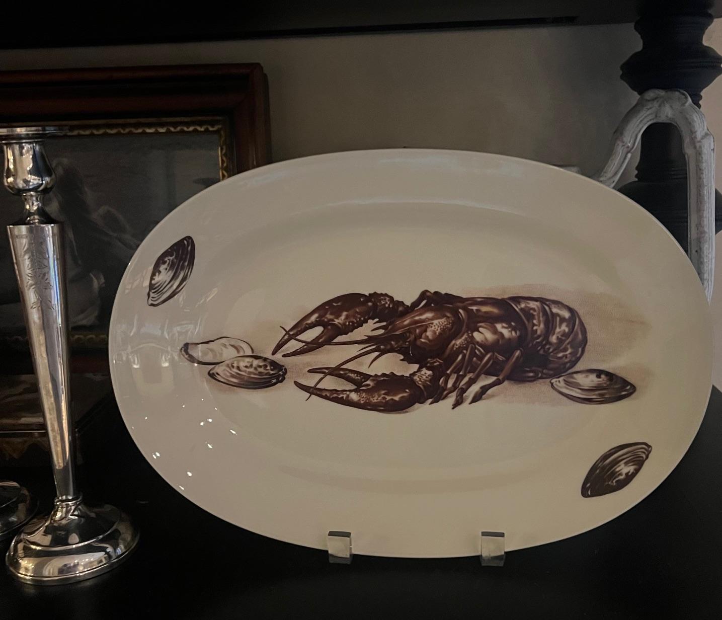 Porcelain lobster service set of eleven pieces, includes ten plates and one tray made by Richard Ginori, made in Italy in the 1960's or 1970's. All pieces include a lobster motif and are stamped by the maker.

Tray measures 13.4  x 9.2
Plates