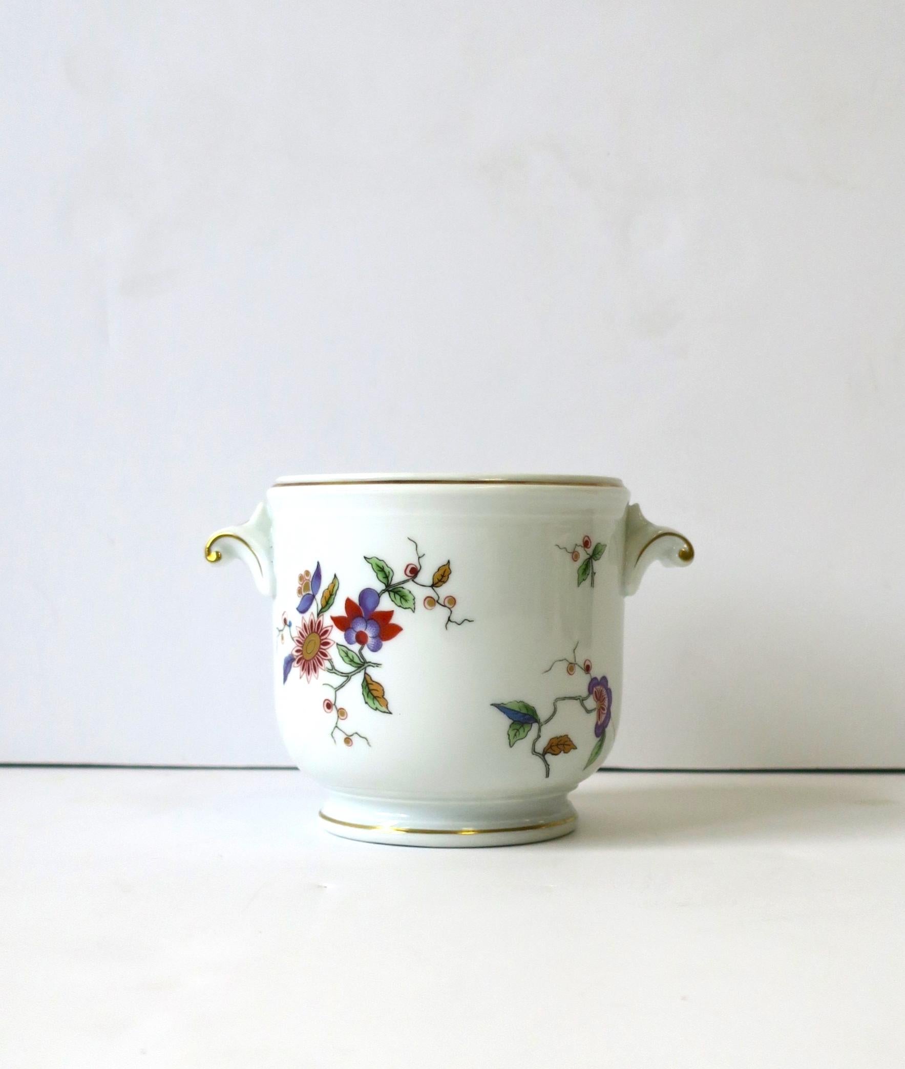 A beautiful, small, vintage Richard Ginori porcelain cachepot with gold and multi-colored floral decoration, circa mid-20th century, Italy. Gold accented handles on sides. Piece can hold a flower or plant (as demonstrated.) Maker's mark on bottom as