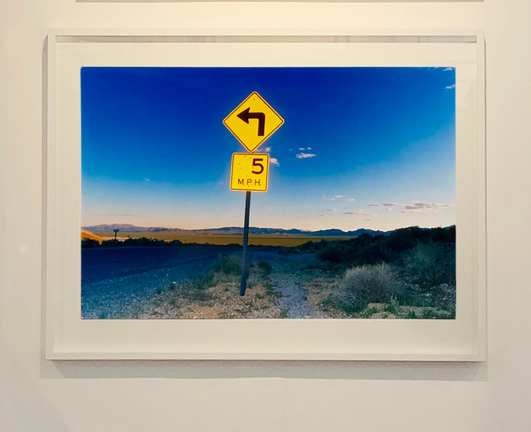 5MPH, Rhyolite, Nevada - American Landscape Color Photography - Blue Landscape Photograph by Richard Heeps