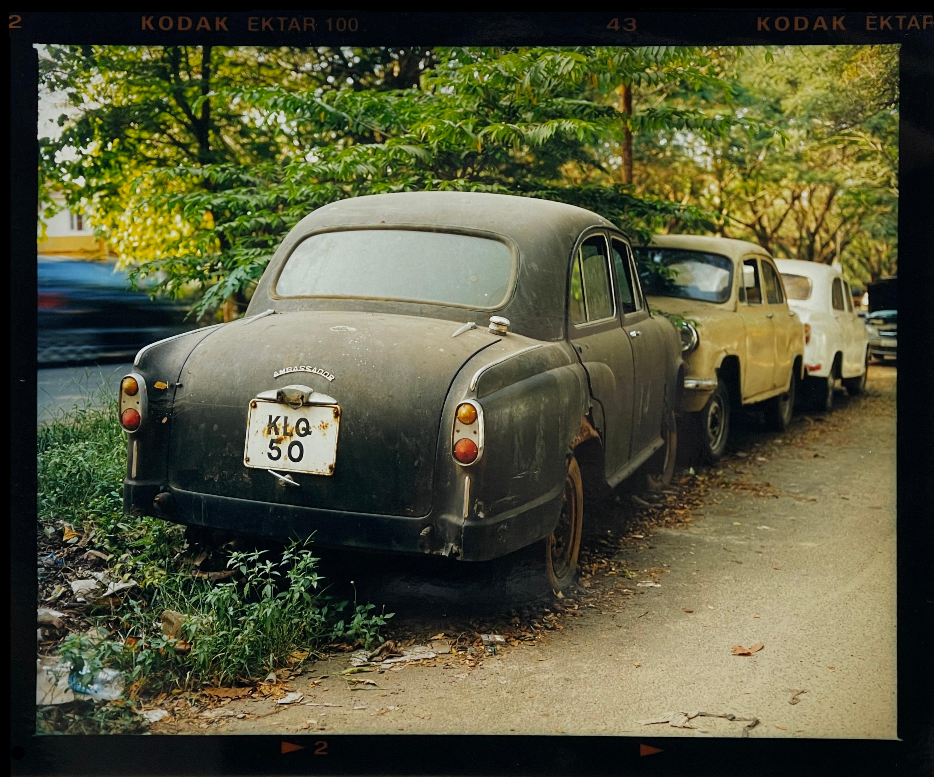 Ambassador cars, a typical sight throughout India, lined up here with a coat of dust, at a roadside garage. From Richard Heeps India series, The Ambassador's Window.

This artwork is a limited edition of 25, gloss photographic print from negative,