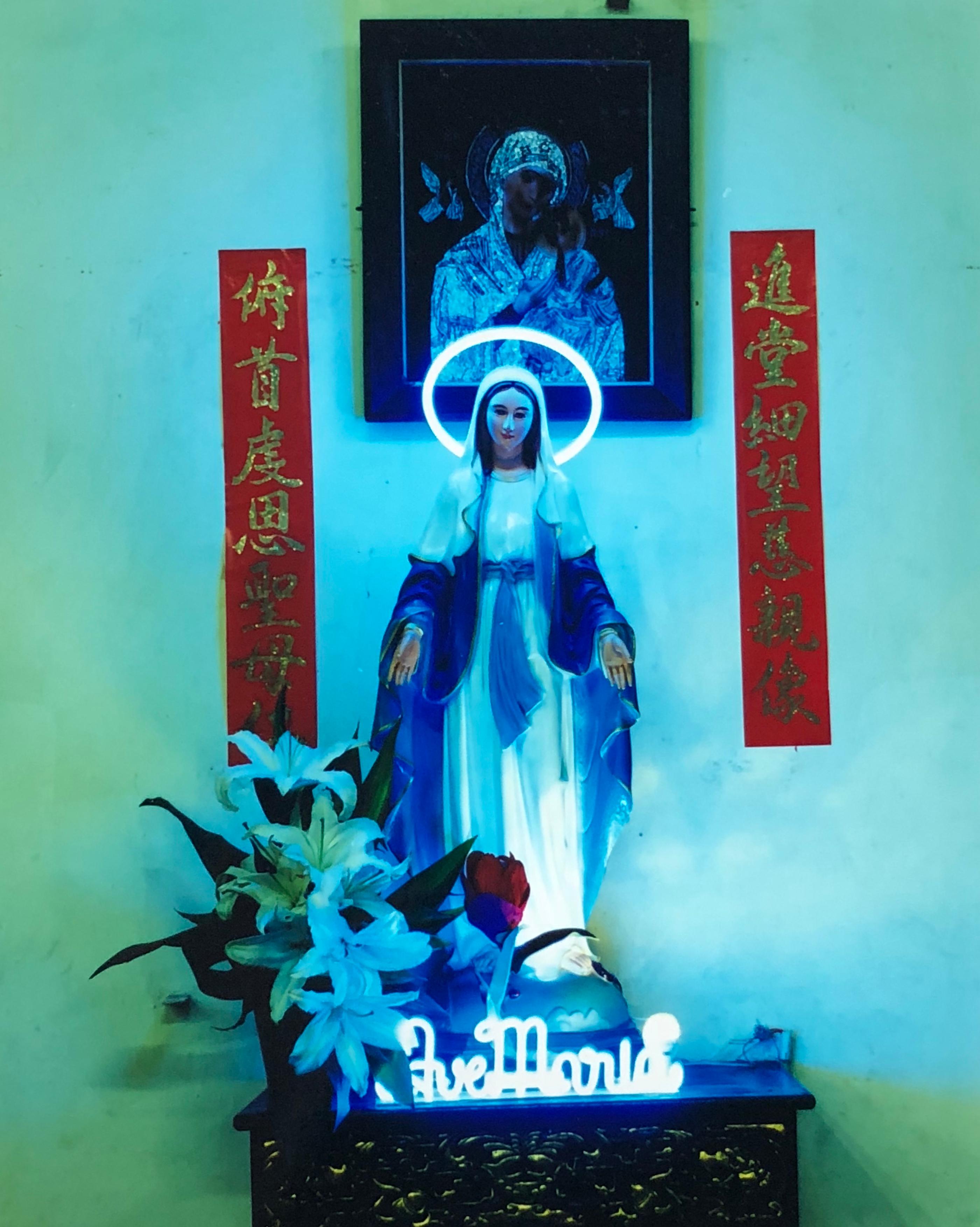 Ave Maria, part of Richard Heeps' 'This is Not America' series photographed in Vietnam in 2016. This striking artwork has a fun religious kitsch vibe, the neon really makes it pop.

This artwork is a limited edition of 25, gloss photographic print,