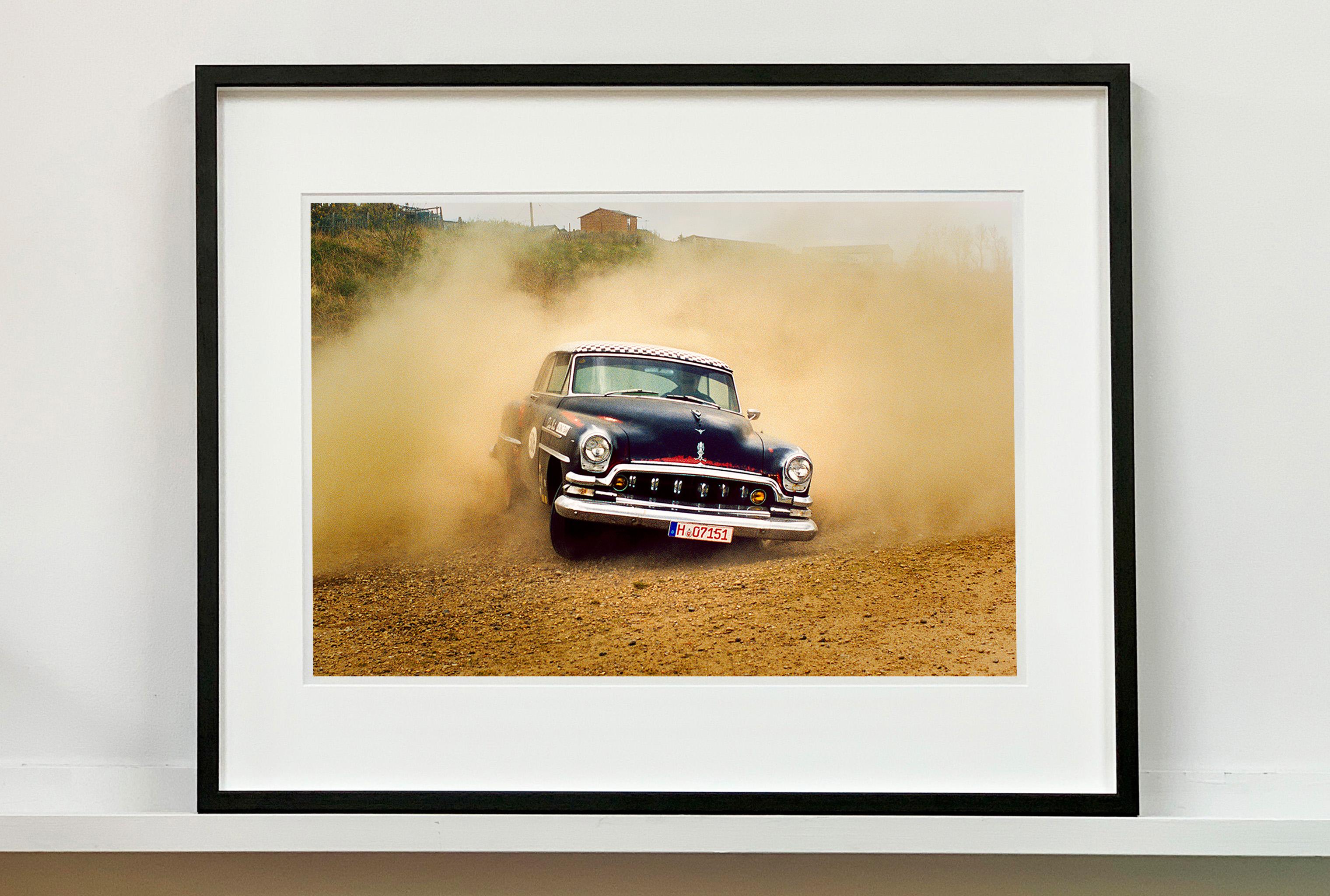 'Donutting' shows a classic American car donut driving on a Norfolk beach in the East of England. This photograph was captured at Hemsby Rock and Roll weekend, and is part of Richard Heeps' Man's Ruin' series.

This artwork is a limited edition