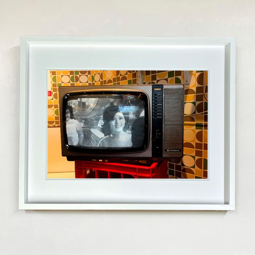 Hitachi TV, photograph by Richard Heeps captured at the top of Victoria Peak in Hong Kong. A sense of nostalgia with seventies inspired mustard wallpaper as a retro kitsch backdrop for a black and white vintage Hitachi TV.

This artwork is a limited