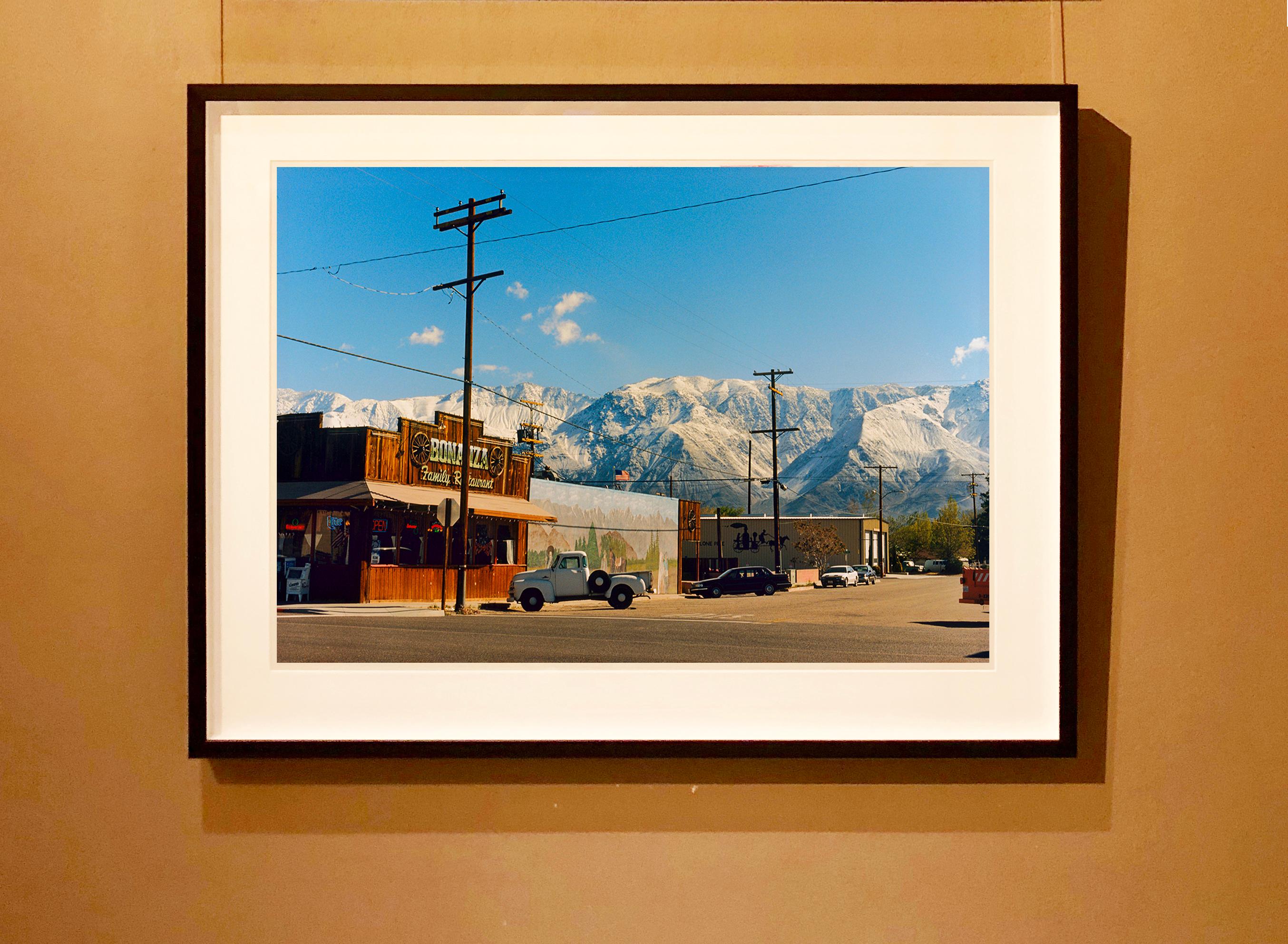 There is a cinematic style to this artwork, Lone Pine, taken in a former movie town in California, many Western films were made there. Taken outside Richard's iconic interior photograph 'Bonanza Café', set in the Owens Valley against a mountain