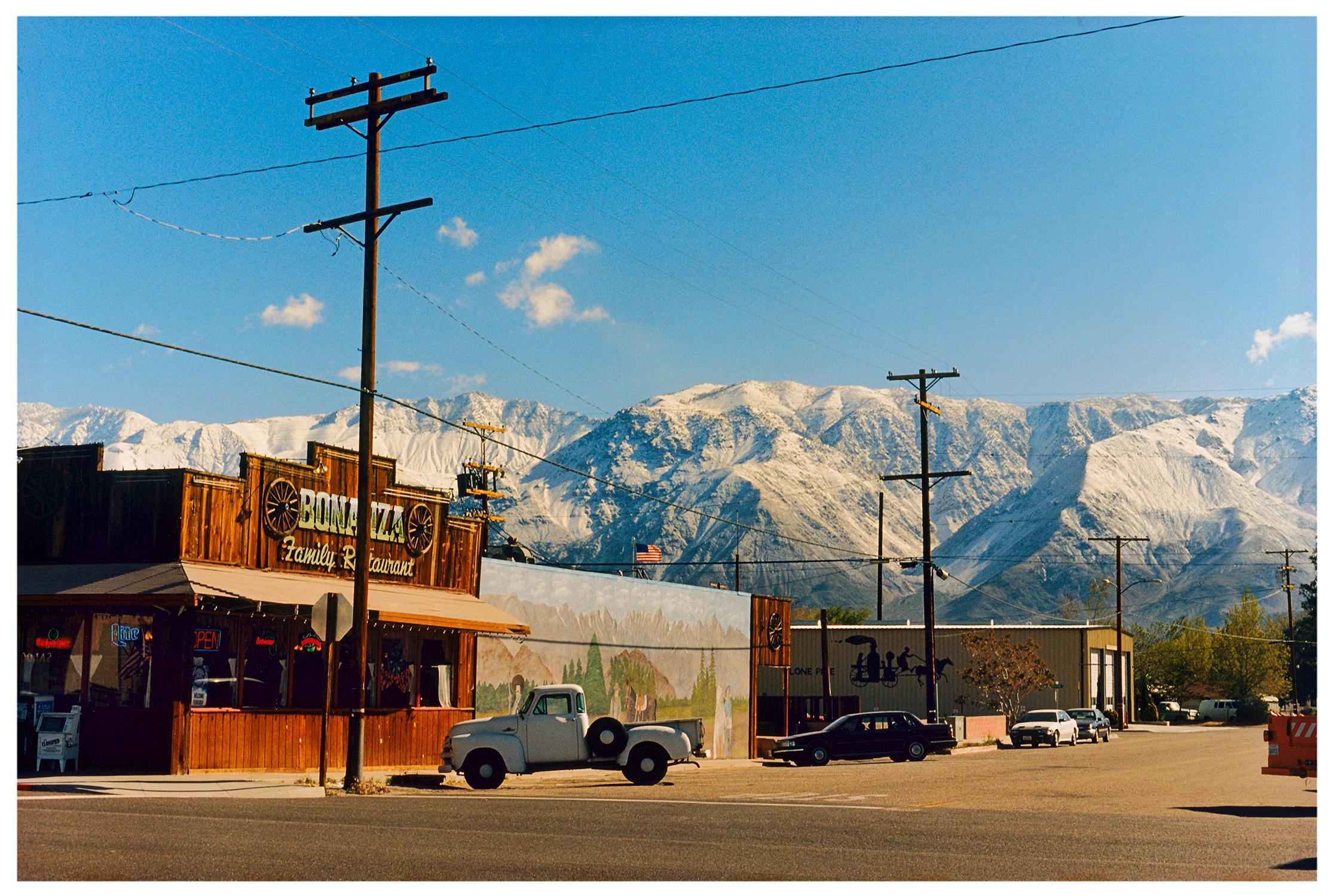 There is a cinematic style to this artwork, Lone Pine, taken in a former movie town in California, many Western films were made there. Taken outside Richard's iconic interior photograph 'Bonanza Café', set in the Owens Valley against a mountain