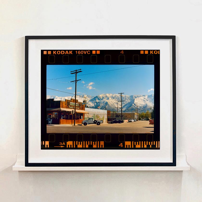 On the Road, reimagines classic Richard Heeps artworks presented with full film rebate almost like a blown up contact sheet. 
There is a cinematic style to this artwork, 'Lone Pine', taken in a former movie town in California where many Western