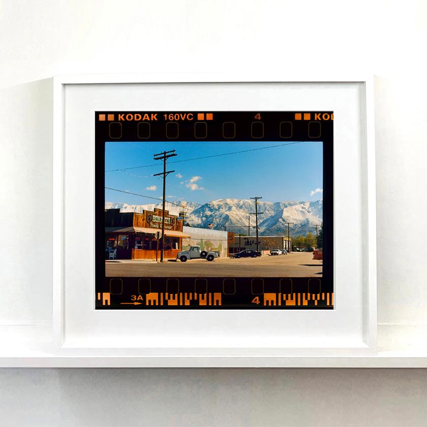 On the Road, reimagines classic Richard Heeps artworks presented with full film rebate almost like a blown up contact sheet. 
There is a cinematic style to this artwork, 'Lone Pine', taken in a former movie town in California where many Western