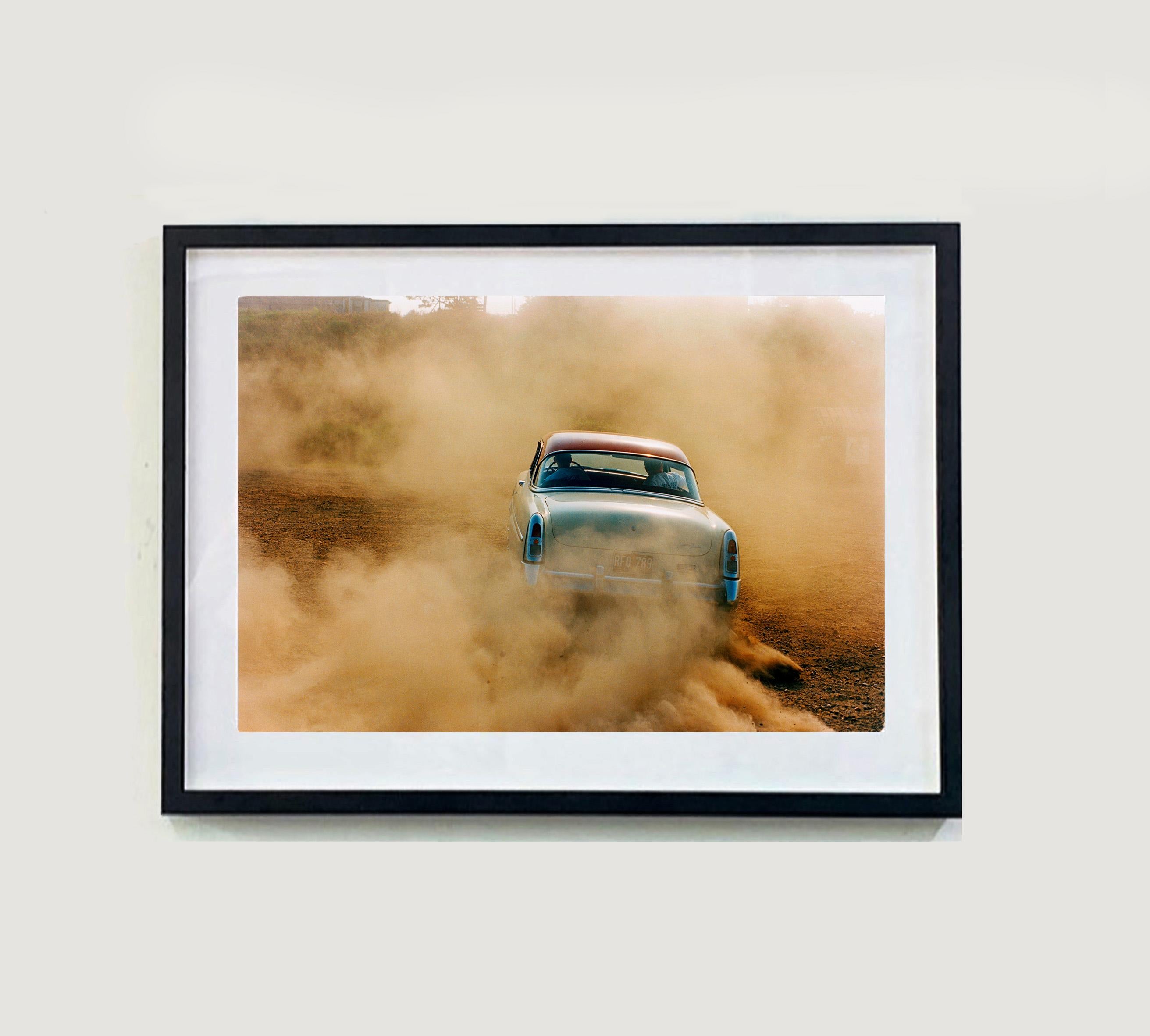 Mercury in the Dust, Hemsby, Norfolk - Car on a beach color photography - Photograph by Richard Heeps