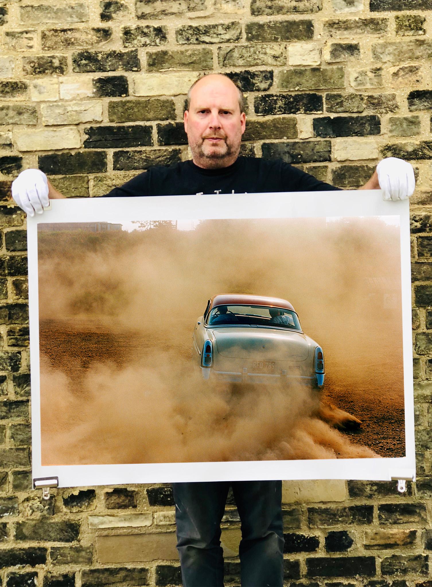 Mercury in the Dust, Hemsby, Norfolk - Car on a beach color photography - Photograph by Richard Heeps