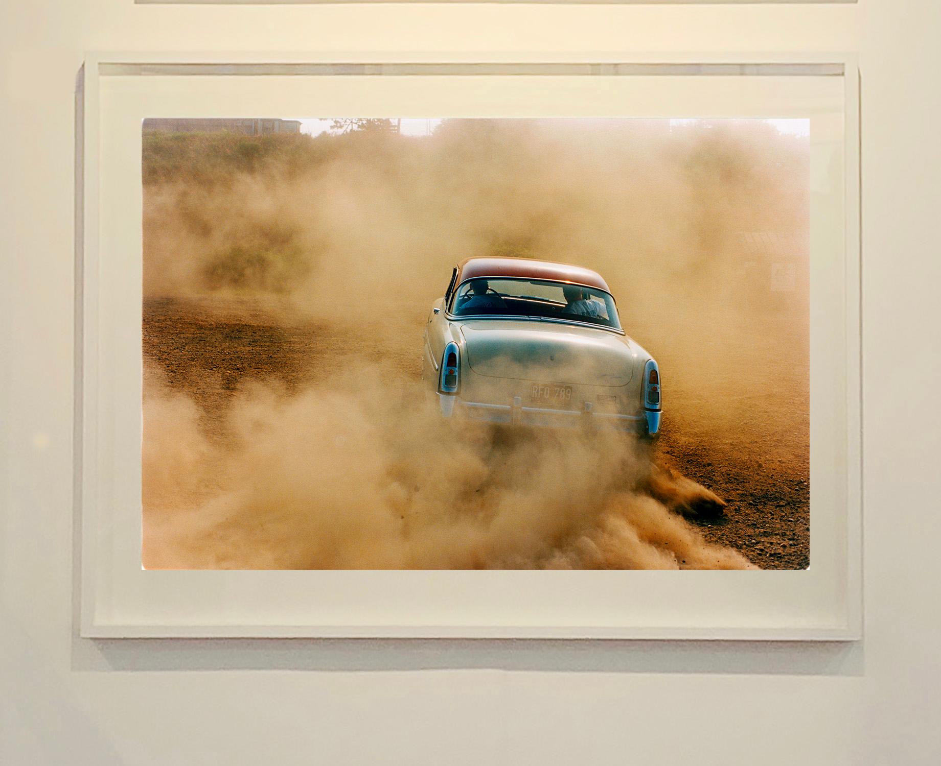 Mercury in the Dust, Hemsby, Norfolk - Car on a beach color photography - Contemporary Photograph by Richard Heeps