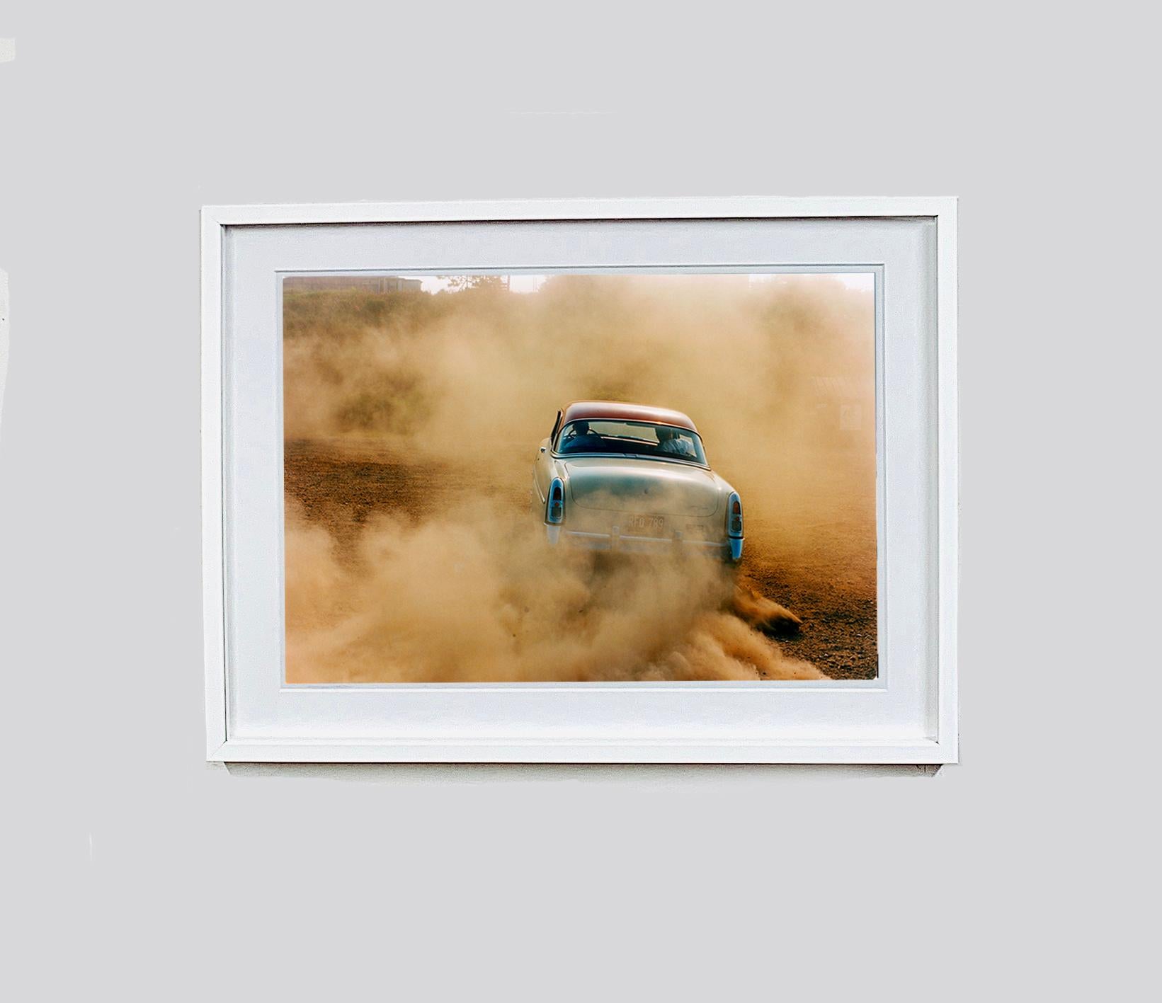 Mercury in the Dust, Hemsby, Norfolk - Car on a beach color photography - Contemporary Photograph by Richard Heeps