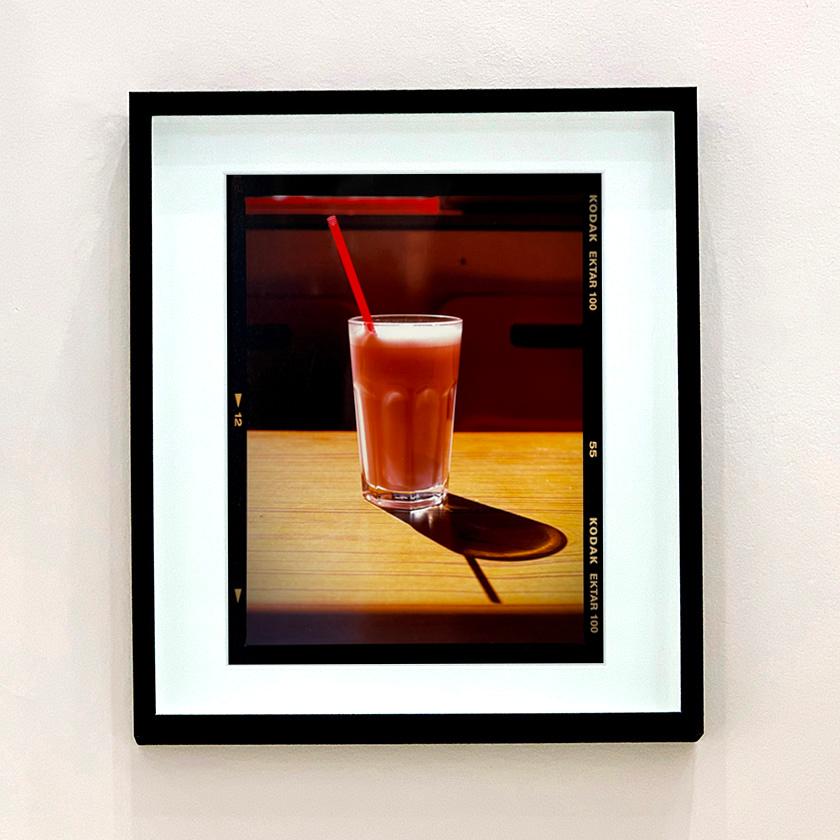 Milkshake, a cold drink on a hot day, captured at the seaside in the year of the great British staycation. This enticing pink milkshake in a glistening glass was photographed by Richard Heeps in a Clacton-on-Sea cafe. The composition of this artwork