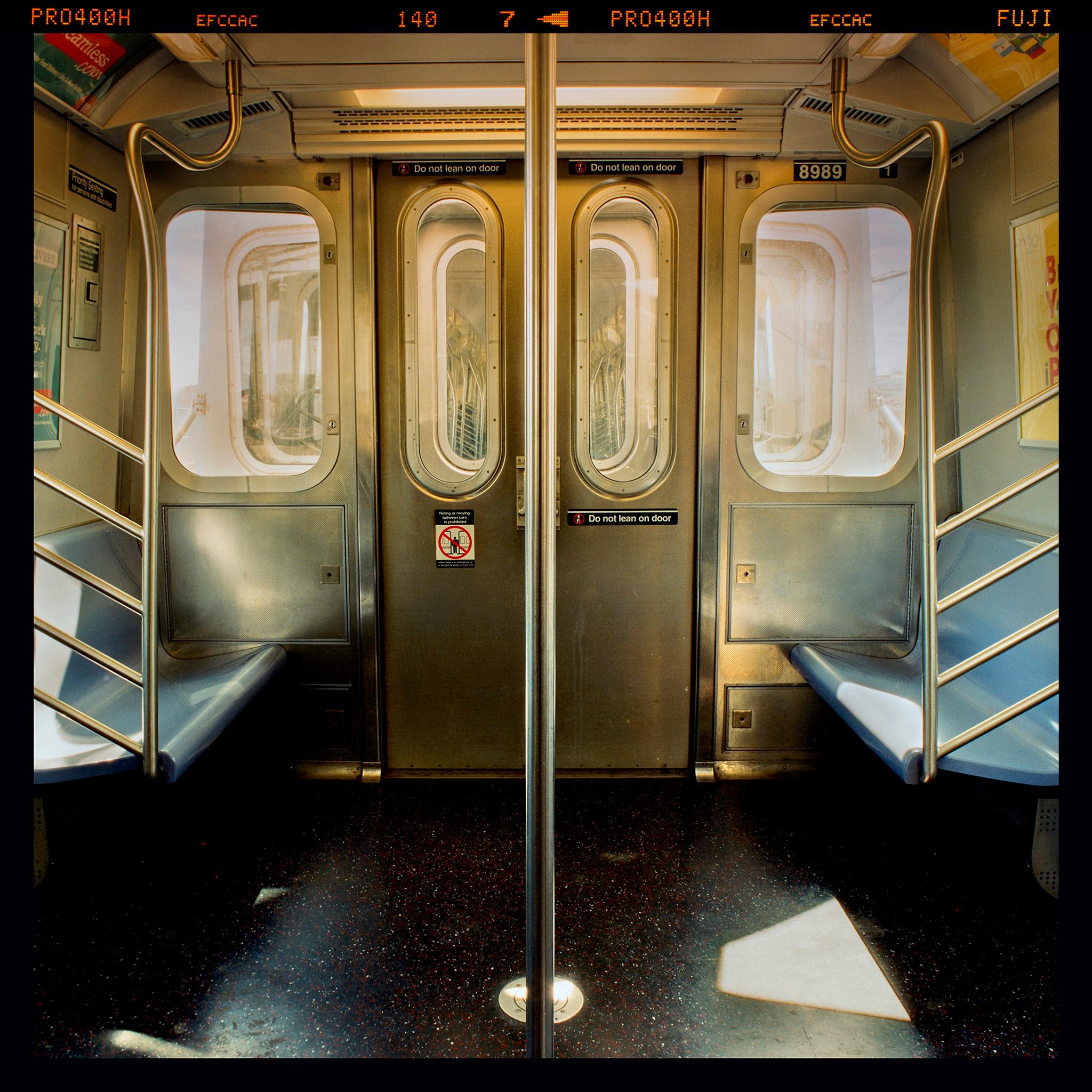 New York City Subway Car interior photograph by Richard Heeps. This atmospheric photograph of a New York City Subway Car captures the cinematic essence of riding the subway. The perspective of the pole in the middle gives the viewer a sense of being