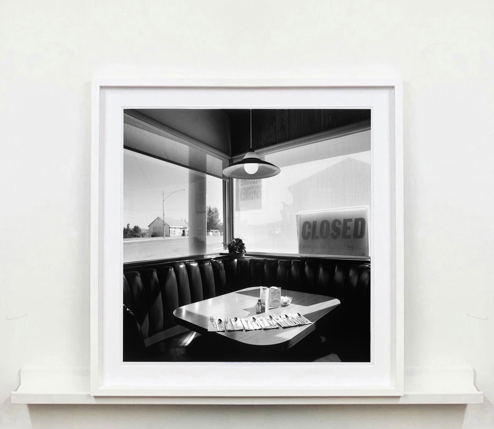 Part of Richard Heeps 'Dream in Colour' Series, 'Nicely's Café' has a vibe of an American road trip, the classic diner interior has a cool cinematic feel.
Primarily known as a color photographer Richard Heeps was commissioned to create this black