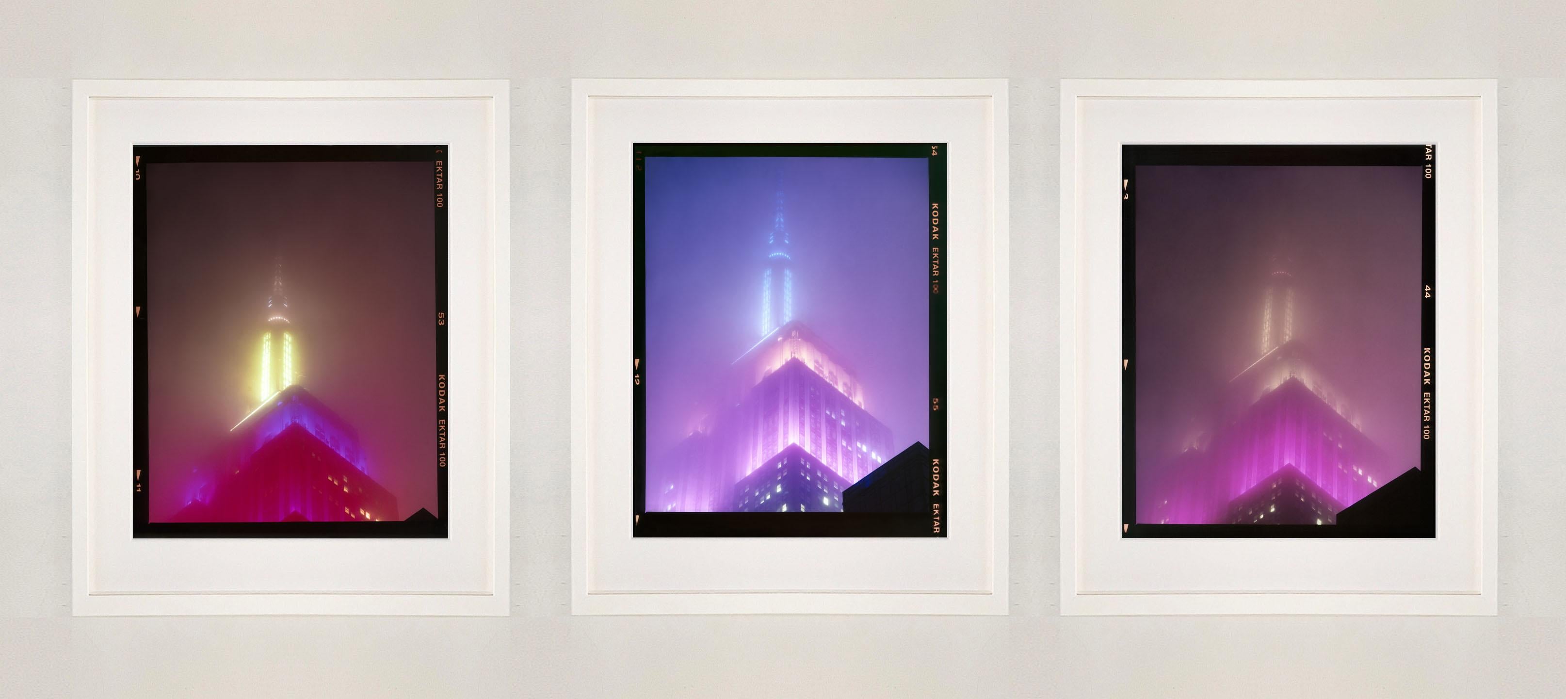 'NOMAD IX (Film Rebate)', New York. Richard Heeps has photographed the iconic Empire State building in the mist. The NOMAD sequence of photographs capture the art deco architecture illuminated by changing colours, and is part of Richard's street