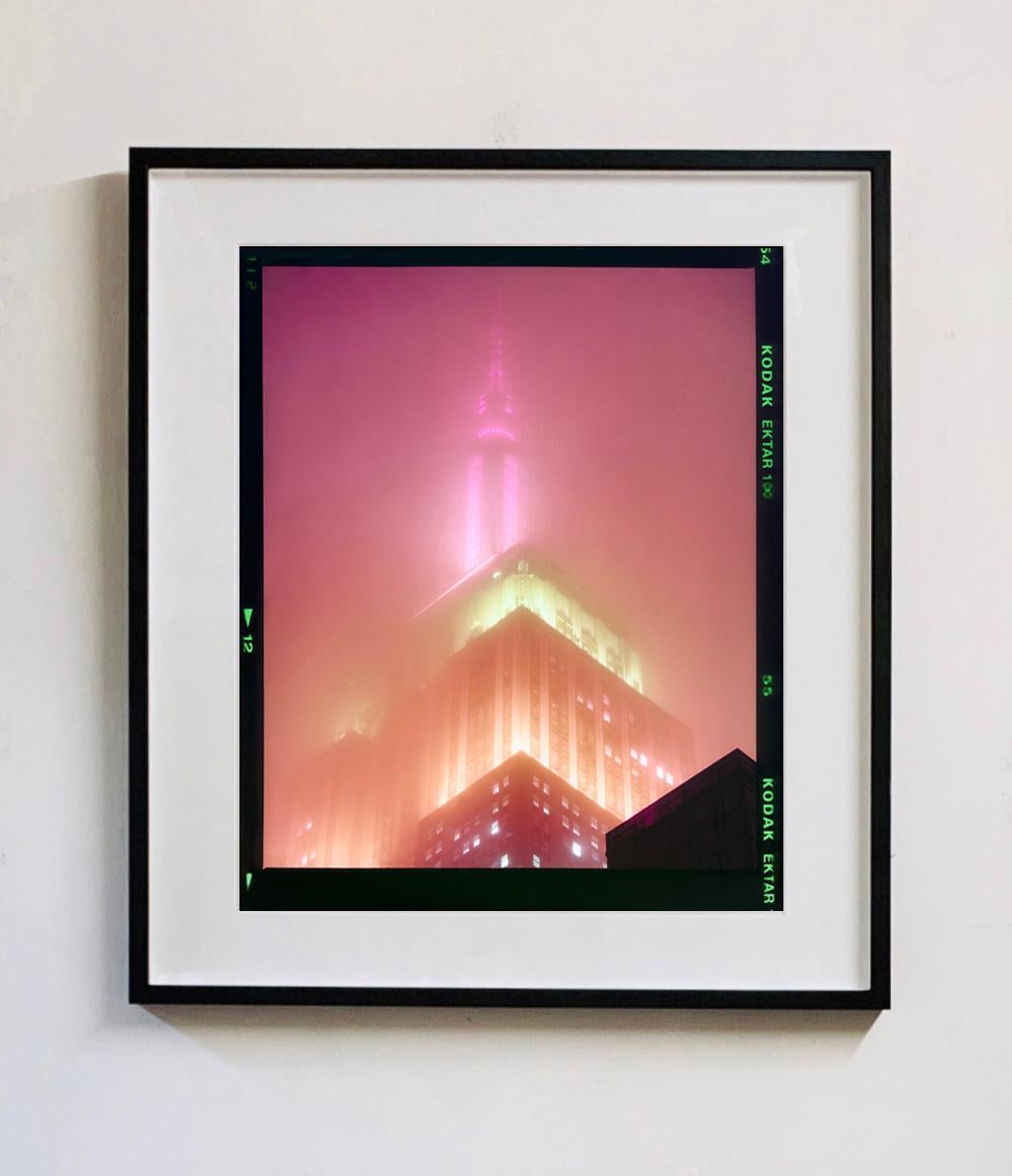 Set of four framed artworks.
'NOMAD (Film Rebate)', New York. Richard Heeps has photographed the iconic Empire State building in the mist. The NOMAD sequence of photographs capture the art deco architecture illuminated by changing colours, and is