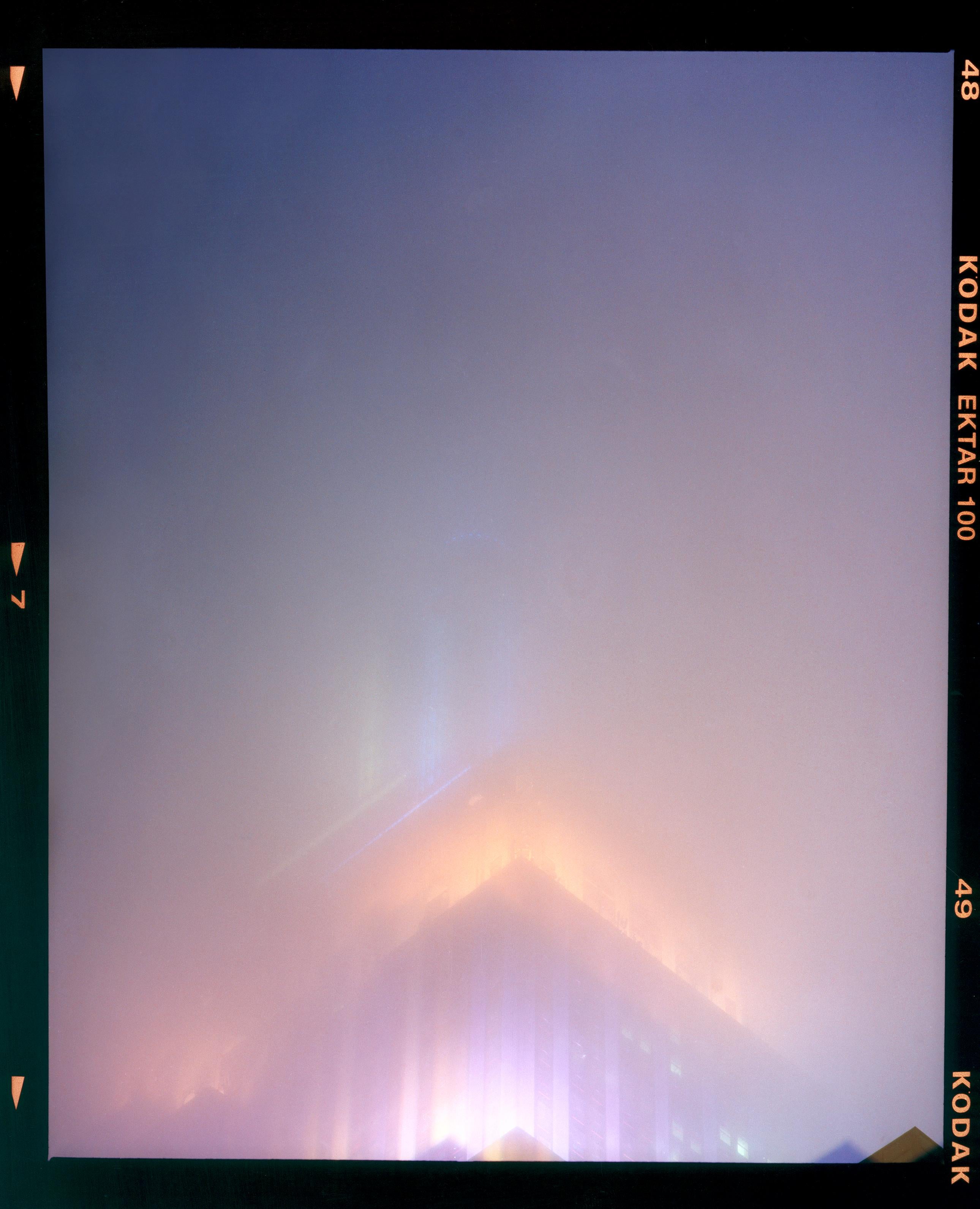 'NOMAD VI (Film Rebate)', New York. Richard Heeps has photographed the iconic Empire State building in the mist. The NOMAD sequence of photographs capture the art deco architecture illuminated by changing colours, and is part of Richard's street