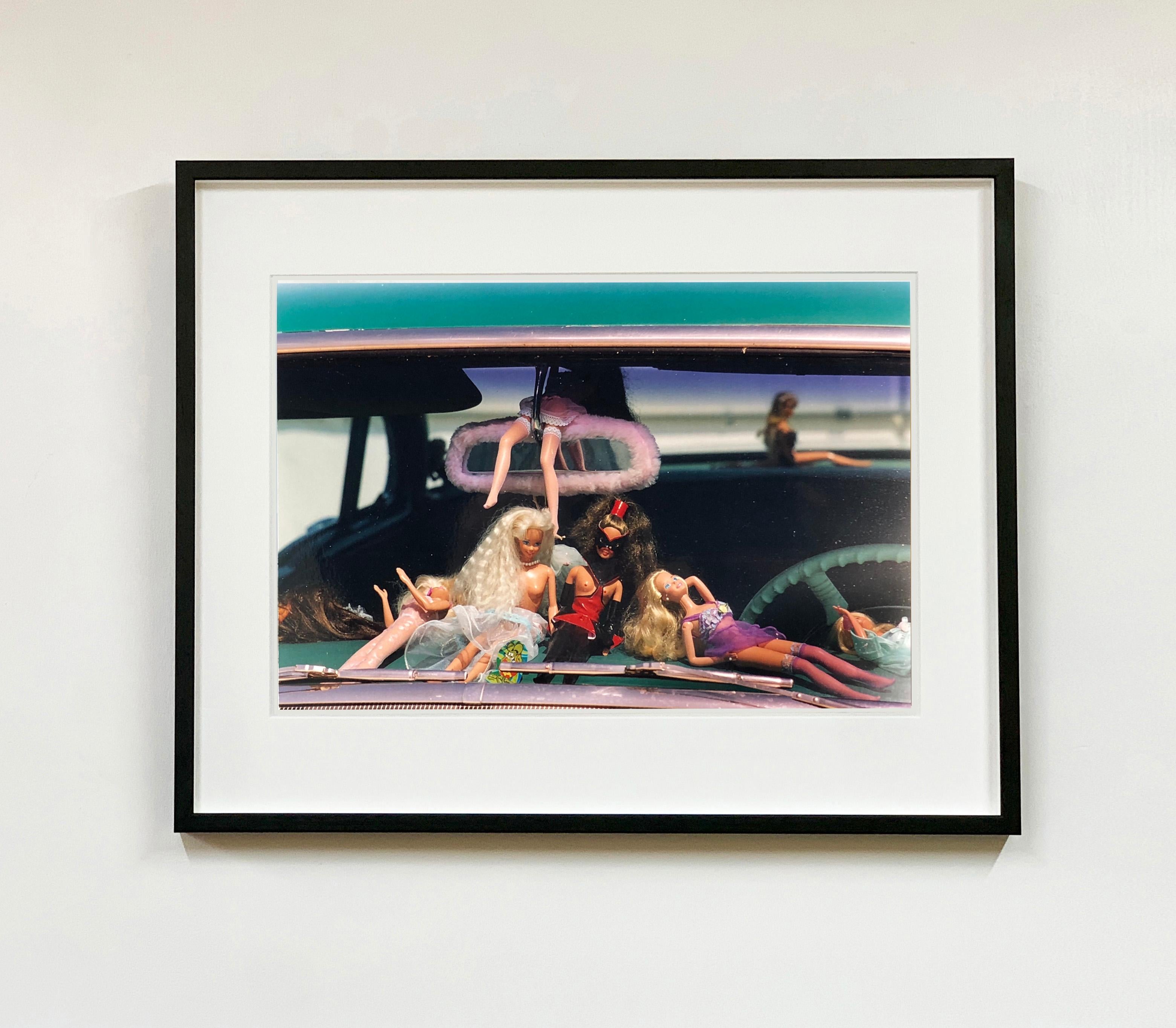 Oldsmobile and Sinful Barbie's, from Richard Heeps' 'Man's Ruin' Series. This artwork is part of a sequence capturing Wendy at the Rockabilly Weekender, Viva Las Vegas, these Barbie's adorn the dashboard of her classic American car, captured through