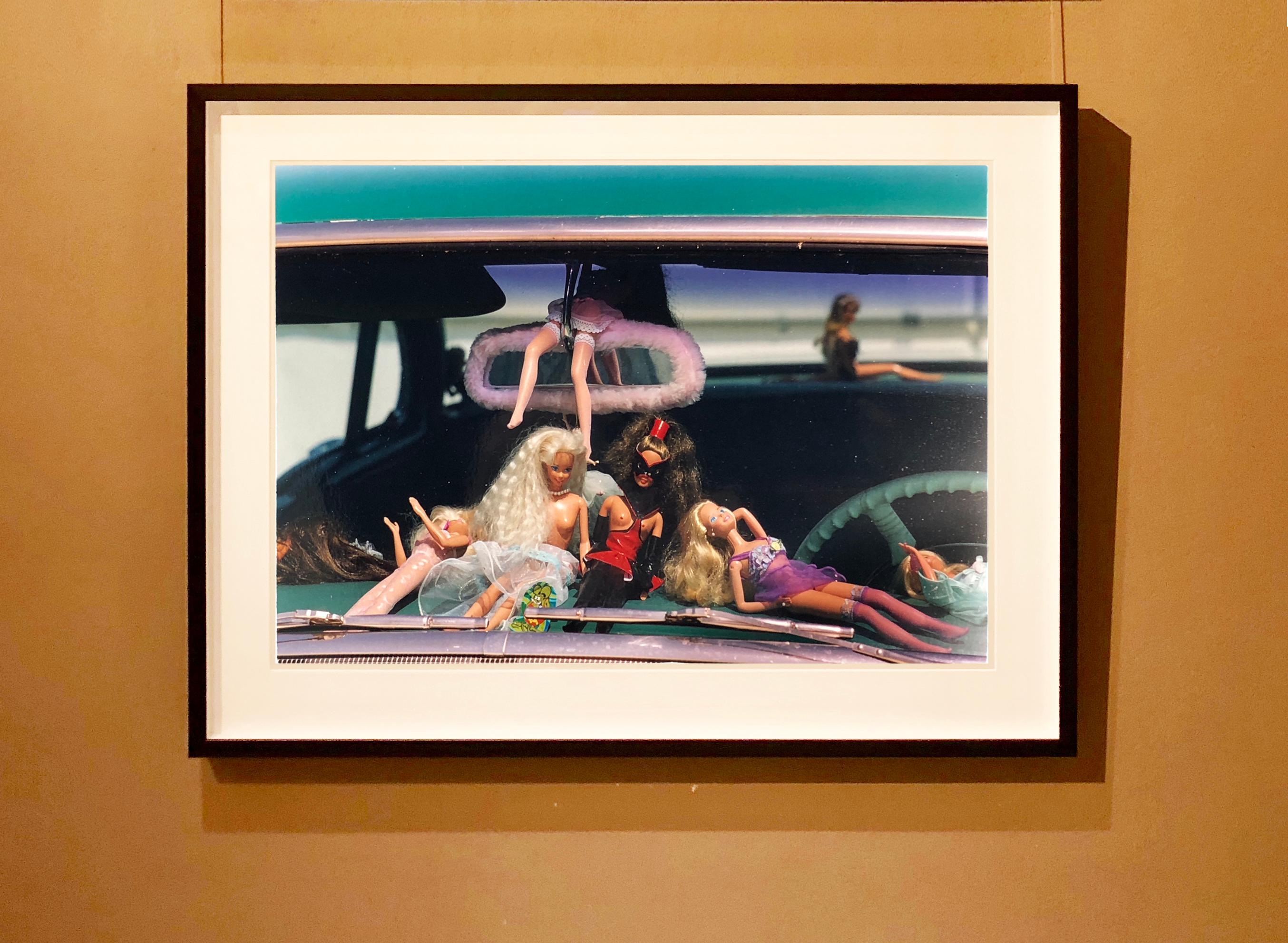 Oldsmobile and Sinful Barbie's, from Richard Heeps' 'Man's Ruin' Series. This artwork is part of a sequence capturing Wendy at the Rockabilly Weekender, Viva Las Vegas, these Barbie's adorn the dashboard of her classic American car. 

This artwork