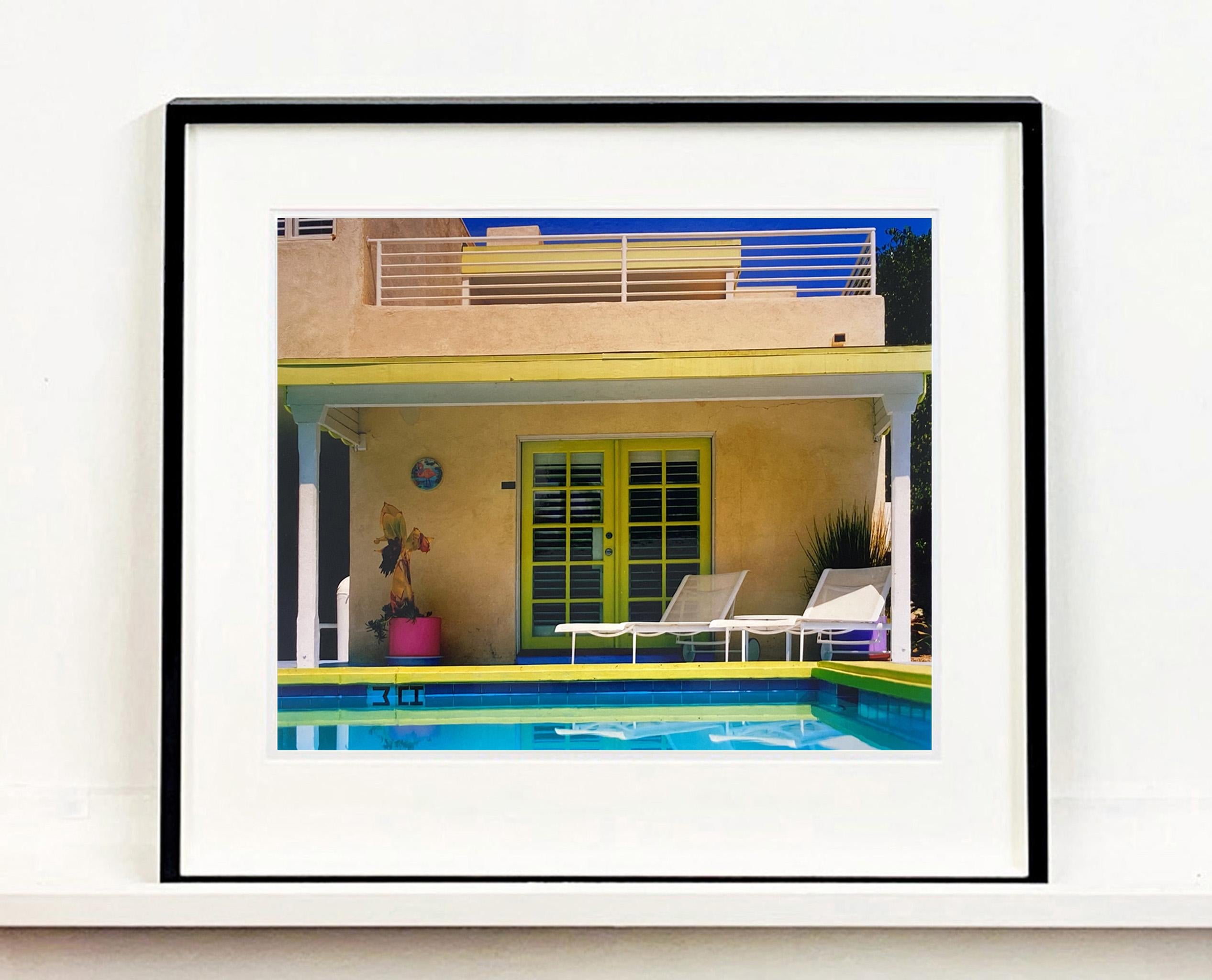 Palm Springs Poolside, photography by Richard Heeps at Ballantines Movie Colony. This artwork captures the classic mid-century Palm Springs architecture set against saturated blue skies and the cool pool with accents of pink and almost neon