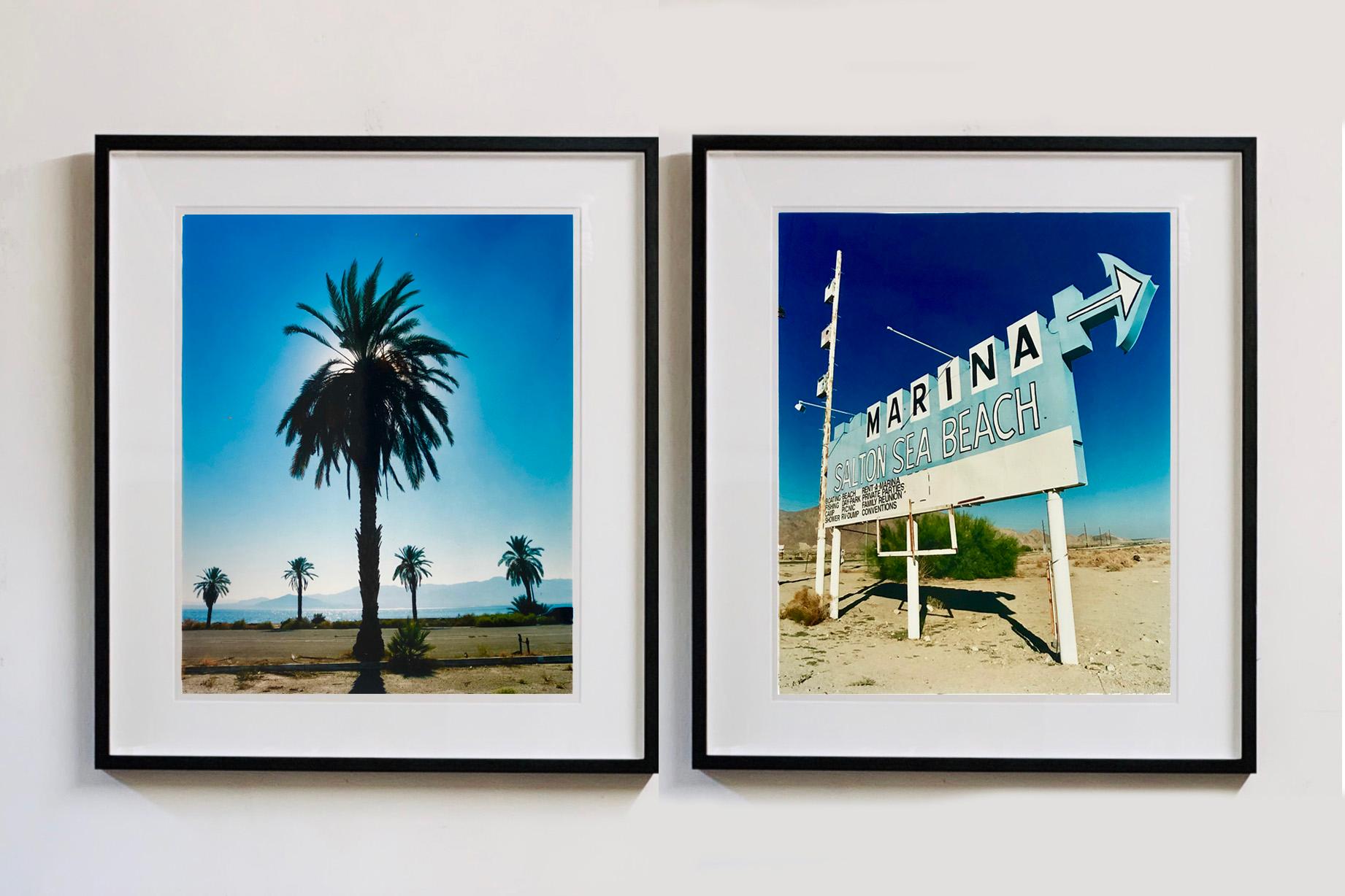 Palm Tree from Richard Heeps photography series Salton Sea. 
You can feel the heat in this classic Palm Tree Print, the almost silhouette of the Palm Tree against the saturated blue sky takes you to a hot sultry day.

This artwork is a limited
