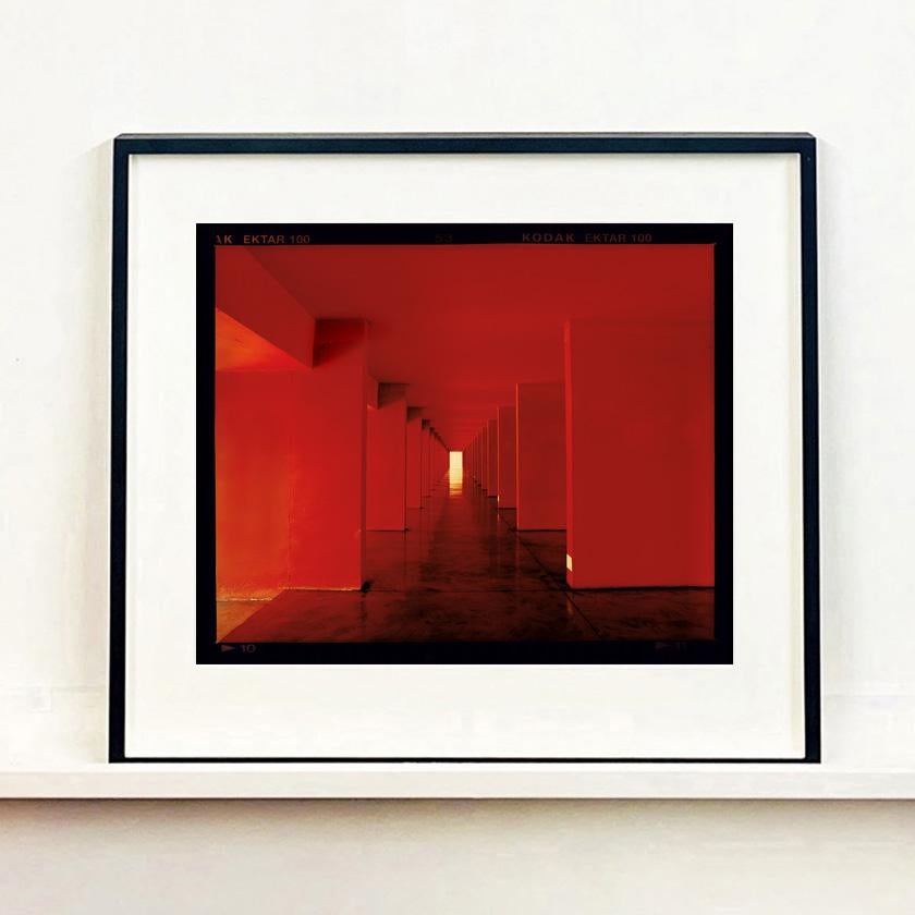 Red Dinosaur II, Milan - Architectural urban color photography - Print by Richard Heeps