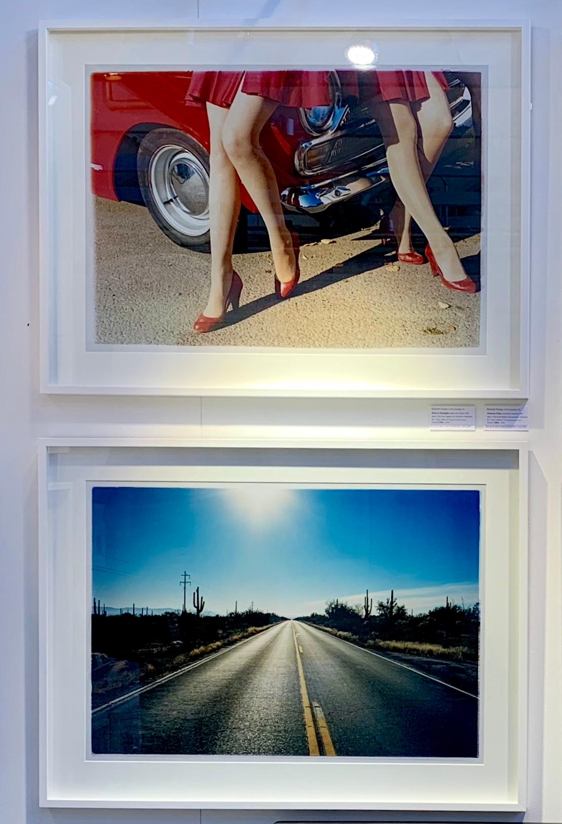 Road to Gunsight, part of Richard Heeps 'Dream in Colour' Series, this is the classic American open road photograph, which is a metaphor of a journey throughout Richard's work. The early morning sunlight in the big blue sky and the road combine to