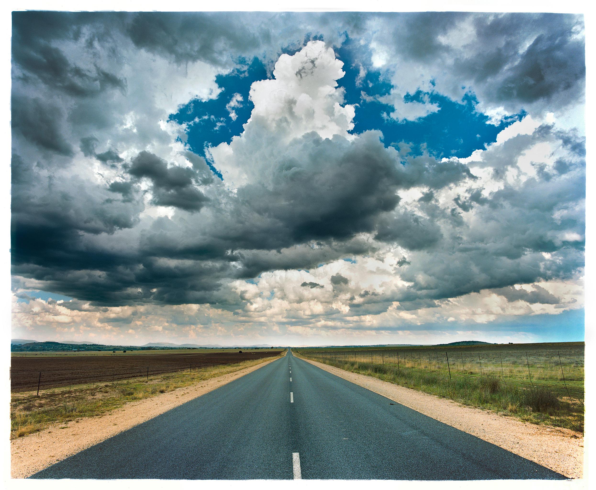 Richard Heeps' work takes you on a journey, the road is a reoccurring theme, often the location is ambiguous allowing you to see your own road trip. The moody sky over over this open road in South Africa, part of a sequence of photographs, including