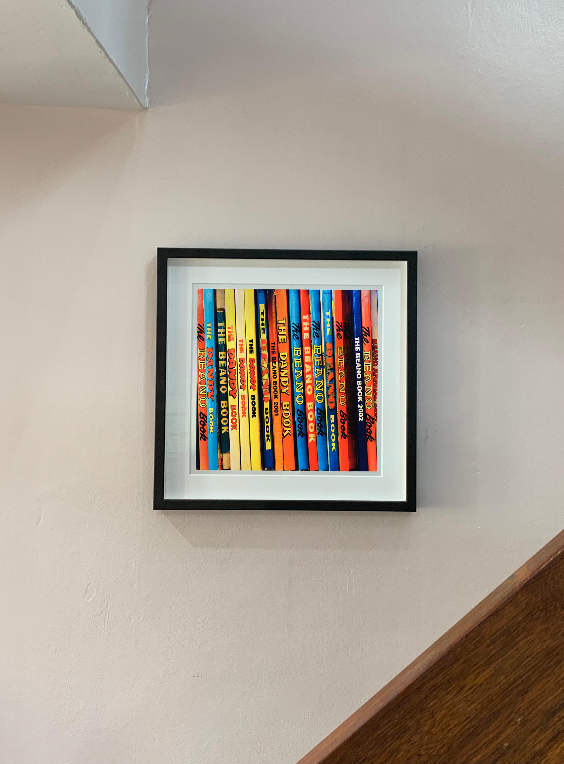 School Fun, from Richard Heeps series 'In The Treasure Trove', featuring the multicolour spines of the iconic children's Annuals, photographed in a vintage bookshop in Burnham Market, Norfolk. 

This artwork is a limited edition of 25, gloss