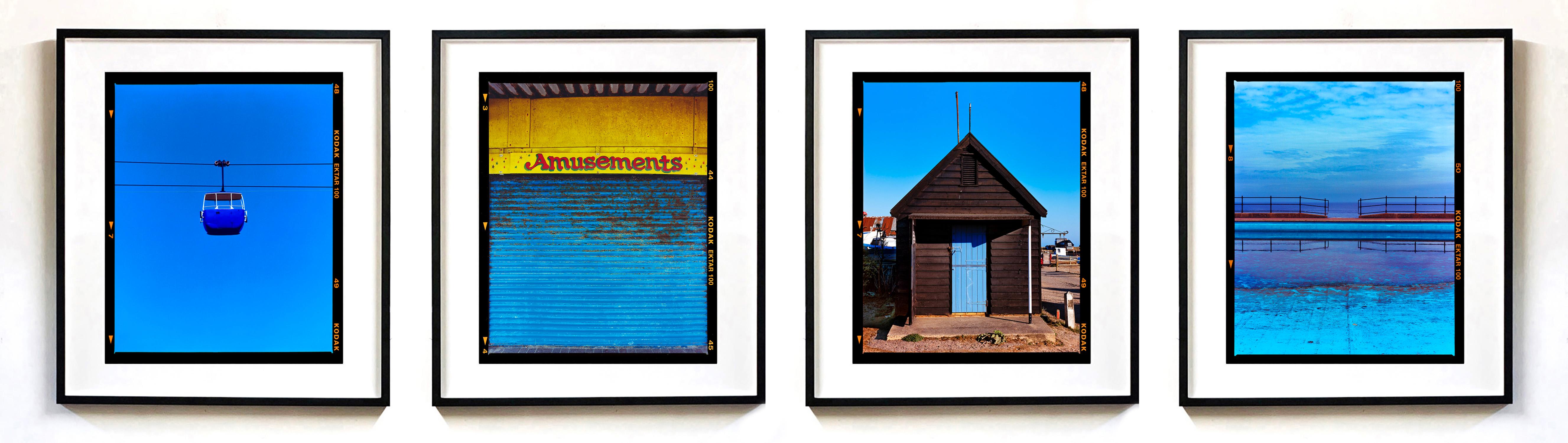 Set of four framed artworks by Richard Heeps capturing the British Seaside Holiday with a signature blue colour theme running through as well as Richard's focus on linear features within the composition. Featuring

Summit Cable Car (Blue), Great