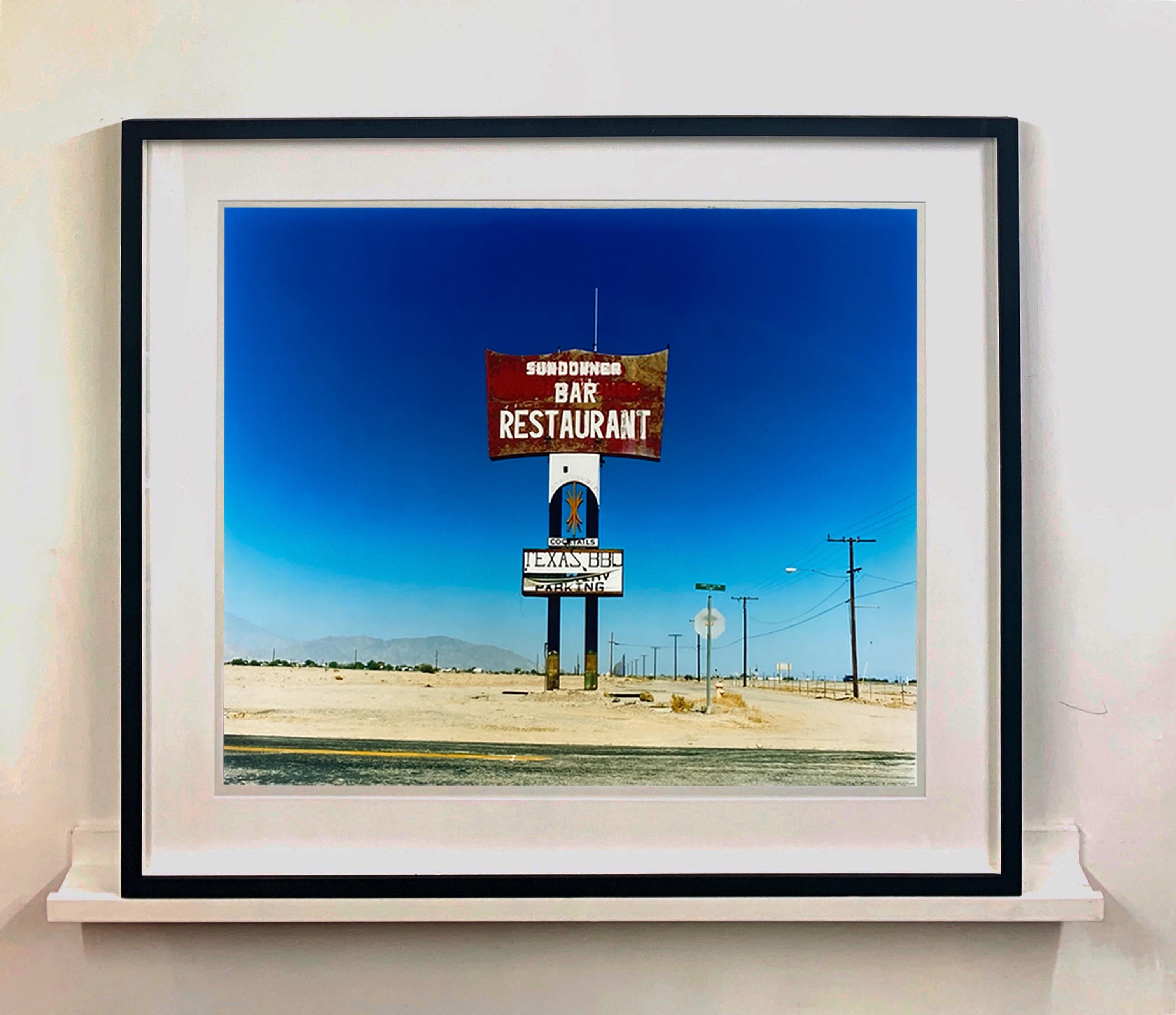This isolated giant great roadside sign set against a vast blue sky is a remnant of The Sundowner Bar and Restaurant of the Motel which is unfortunately no more. This photograph, part of Richard Heeps Salton Sea Series captures the landscape of the