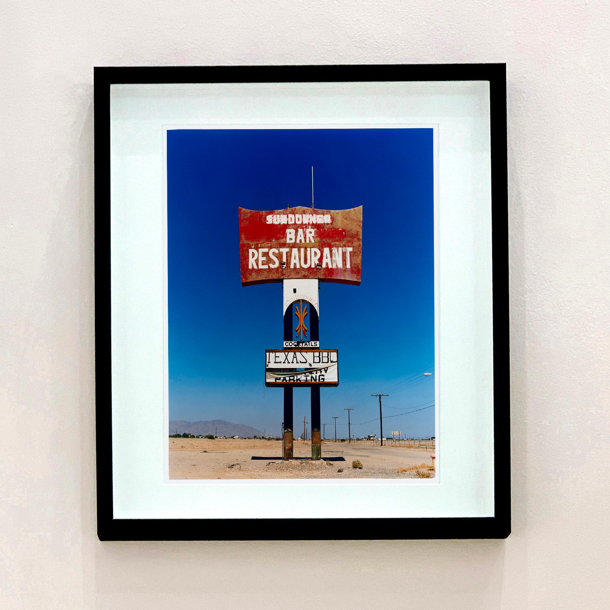 Sundowner Sign, Salton Sea, California - American Landscape Color Photography - Blue Landscape Photograph by Richard Heeps