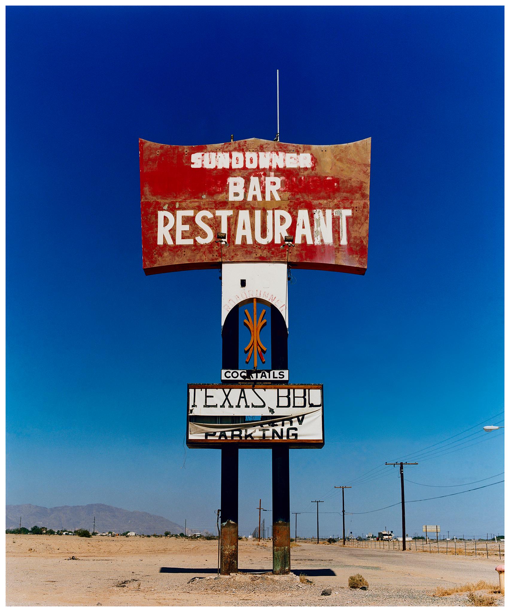 Richard Heeps Landscape Photograph - Sundowner Sign, Salton Sea, California - American Landscape Color Photography