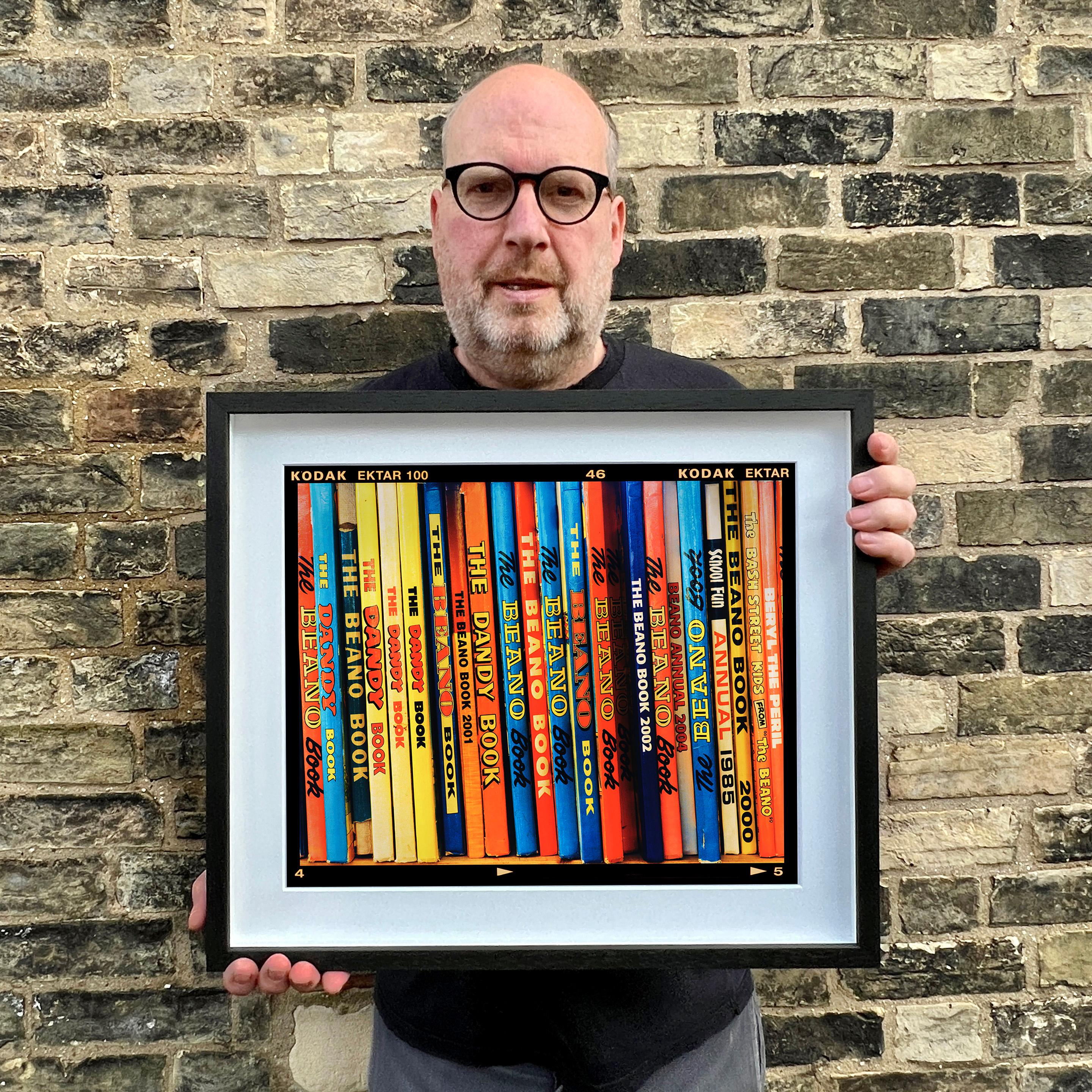 The Rovers, vintage books photograph from Richard Heeps series 'In The Treasure Trove', featuring the multicolour spines of the iconic children's Annuals, photographed in a vintage bookshop in Burnham Market, Norfolk. Printed full frame in Richard's