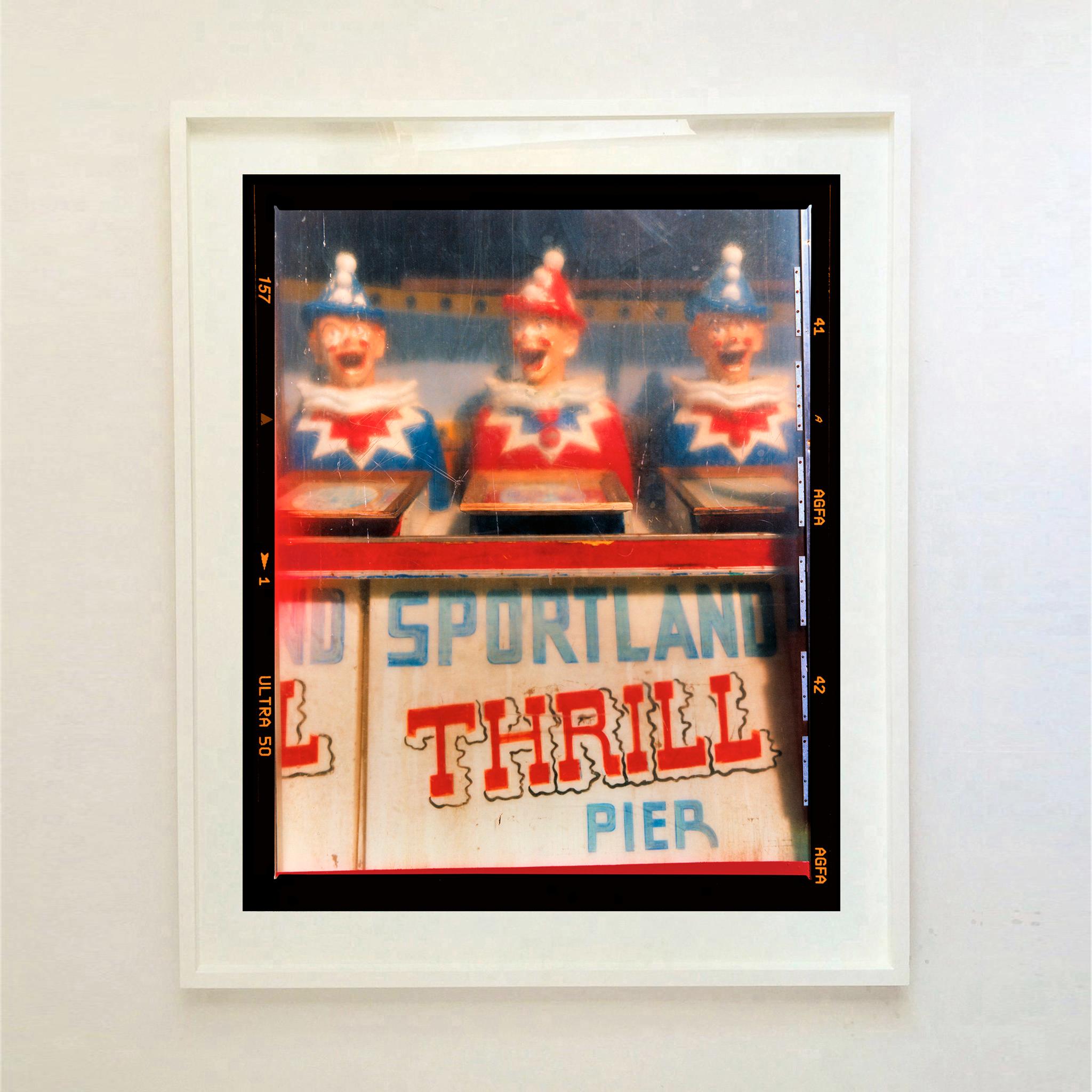 Thrill Pier, vintage seaside amusements clowns photograph from Richard Heeps Jersey Shore series.

This artwork is a limited edition of 25, gloss photographic print, dry-mounted to aluminium, it is presented in a museum board white window mount and