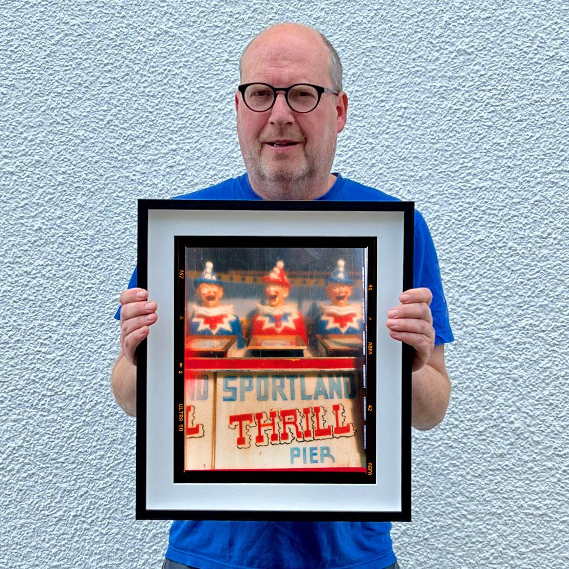 Thrill Pier, vintage seaside amusements clowns photograph from Richard Heeps Jersey Shore series.

This artwork is a limited edition of 25, gloss photographic print, dry-mounted to aluminium, it is presented in a museum board white window mount and