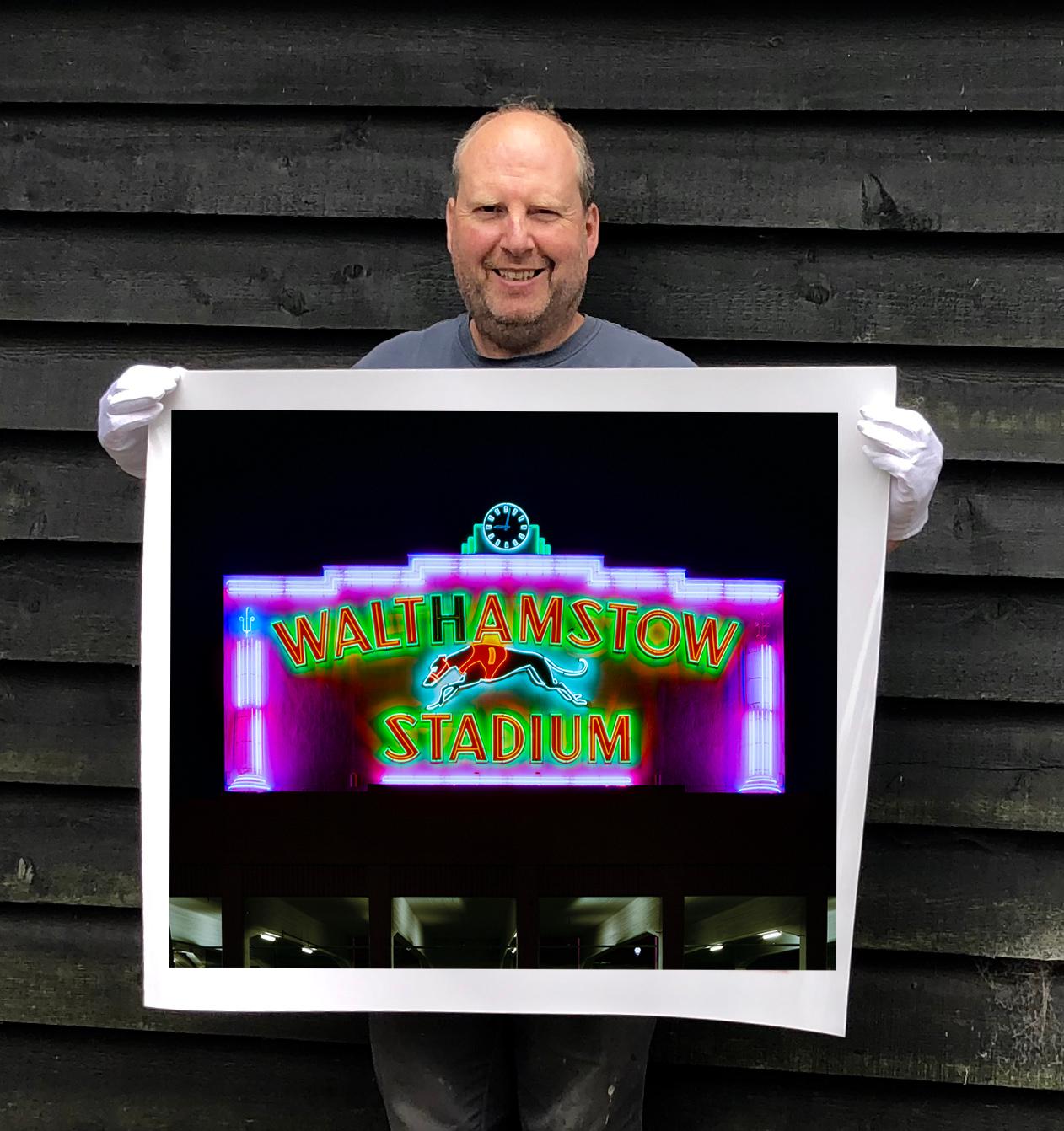 Iconic neon from London's North Circular landmark, the Walthamstow Stadium.

This artwork is a limited edition of 25, gloss photographic print, dry-mounted to aluminium, presented in a museum board white window mount and a choice of black or white