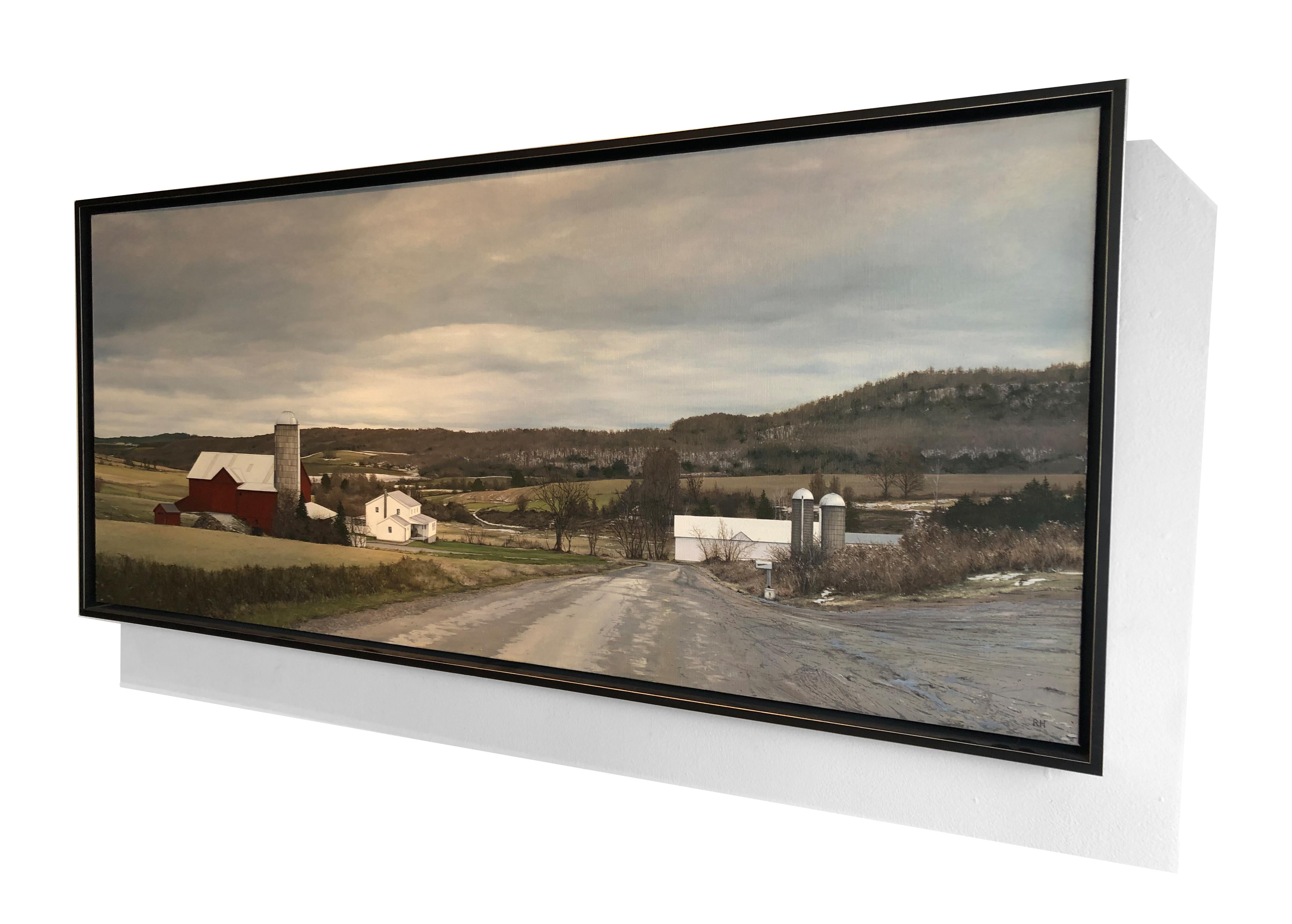 “Somewhere Near Woodhull, NY” is a photorealist oil on canvas painting. The work features a sprawling farm located in upstate New York. The light dusting of snow in the background suggests this is a winter scene. Richard Heisler's work arises from