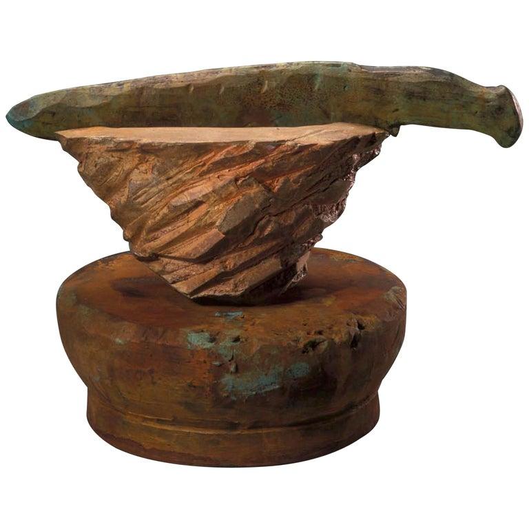 Contemporary American ceramic artist Richard Hirsch and American ceramic artist Peter Voulkos' Altar Bowl with Weapon is raku-fired, hand built and hand sculptured. It was fired in Peter Callas' wood fired kiln during a workshop with Richard Hirsch,