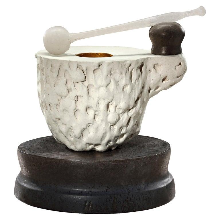 Contemporary American ceramic artist Richard Hirsch's Mortar and Glass Pestle Sculpture #1 was assembled in 2020. It's wheel thrown and hand built clay, gold enamel paint, black and white glazes with hot blown glass. Two separate pieces of stoneware