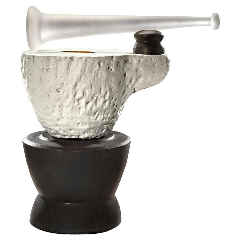 Contemporary American ceramic artist Richard Hirsch's Mortar and Glass Pestle Sculpture #2 was assembled in 2020. It's wheel thrown and hand built clay, gold enamel paint, black and white glazes with hot blown glass. Two separate pieces of stoneware