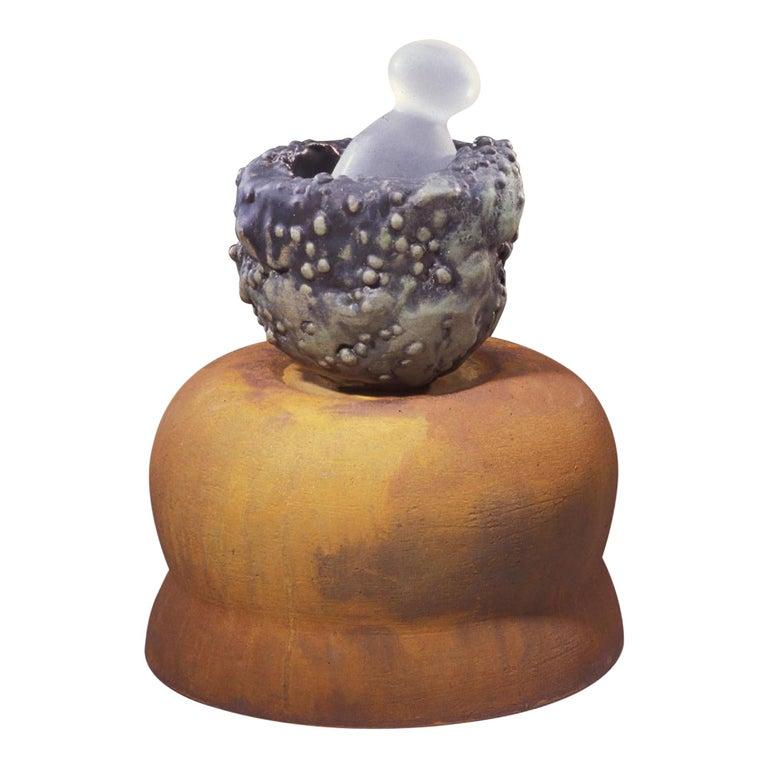 Contemporary American ceramic artist Richard Hirsch's Mortar and Glass Pestle Sculpture #1 was assembled in 2007. It's wheel thrown and hand built clay with green and black watermelon glaze, raku rust patina and hot blown glass. Two separate pieces